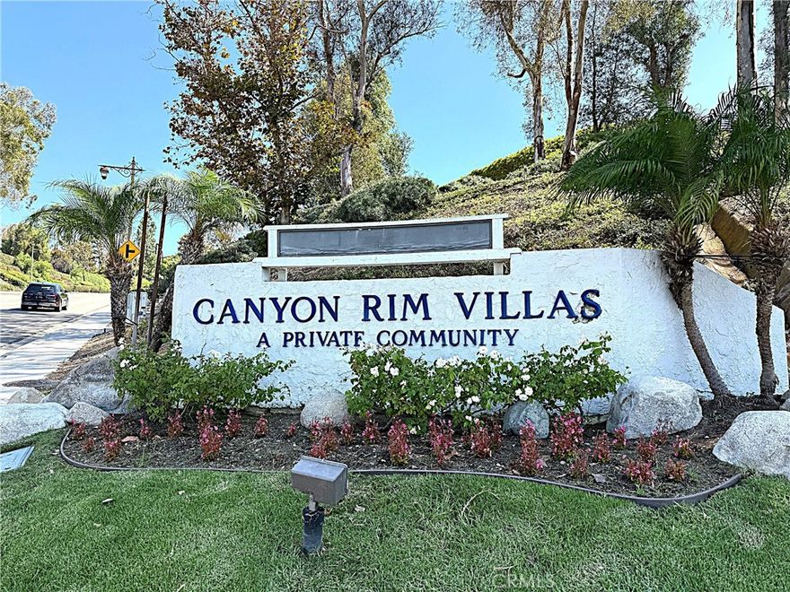 Discover a condo that offers stunning views, with the occasional sighting of deer or rabbits wandering across the golf course, all from the comfort of your condo. This upper-level end unit features two bedrooms and two bathrooms, with each bedroom and bathroom located on either side of the living room for added privacy. The condo has been freshly painted and boasts brand-new carpet in neutral tones. The kitchen provides ample cabinet space and includes a dishwasher, stove, and microwave, along with a breakfast bar for entertaining and additional seating. The dining room connects to a spacious living room with vaulted ceilings, making the space feel larger than its 1,200 square feet. The living room also opens to a large balcony that spans the length of the condo which includes a spacious storage closet and offers spectacular views of Anaheim Hills. The first bedroom features mirrored wardrobe doors, new carpet, and views of the city lights and foothills. The guest bathroom has been updated and offers a tub/shower combo with upgraded tile floors that flow into the hallway, front entry, and kitchen. The primary bedroom is spacious and also offers stunning scenic views. The primary bathroom features a wall of mirrored closet doors that leads into an updated bathroom with a custom shower with glass doors. The laundry is conveniently located in a closet inside the unit and includes a stackable washer and dryer. The community also has laundry facilities that include five washers and dryers available for residents' use. The detached carport area provides additional storage and is just around the corner from the condo. The community features a pool and spa, which is a very short walk from the unit. However, it is far enough away that your unit remains private and feels like a tranquil retreat in nature. Residents are also eligible for one additional parking pass for the open area, which comes with an annual fee to tenants. The location provides easy access to the 91 and 55 freeways and is within walking distance to shopping and schools. Rent includes water and trash services. Hurry before this one is leased!