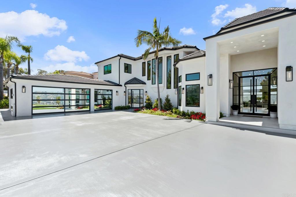 An Architectural statement with 320° unobstructed views from the mountains to the ocean, this reimagined Mount Helix estate blends modern design with Elevated Luxury. Privately gated and set on a rare .77-acre flat, usable lot, it features an oversized driveway and expansive outdoor space ideal for entertaining or future additions. Inside, soaring cathedral ceilings, floor-to-ceiling windows, and designer lighting frame a grand open-concept living area. The chef’s kitchen stuns with Thermador appliances, Sub-Zero refrigeration and wine storage, quartz waterfall island, and slide-away pocketing doors that open to a spacious deck and backyard. The main-level primary suite offers resort-style luxury with an oversized soaking tub, dual vanities, and dual walk-in closets. Upstairs: a second full primary suite and two large bedrooms, each with en-suite baths. A dedicated office, powder room, and oversized laundry complete this offering. This is more than a home—it’s "The One" that sets the bar.