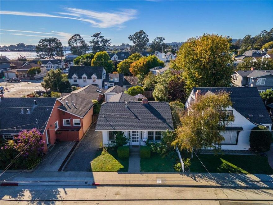 Located just steps from Seabright Beach and the Santa Cruz Yacht Harbor, this charming single-level bungalow offers the quintessential beach lifestyle. Enjoy morning coffee with ocean breezes and the soothing sound of waves in the distance. A spacious living room, vintage built-ins and a separate dining room add character, while the generously sized kitchen opens to a private backyard with a patio and a productive orange tree. A detached garage provides added storage. Walk to Aldos, Tramonti, Lindas and more. This is an incredible opportunity to own a slice of classic Santa Cruz in one of its most beloved neighborhoods.