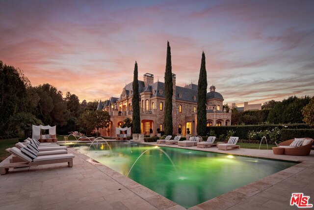 Rarely does an estate of this magnitude & exquisite craftsmanship come to market in the prestigious enclave of Beverly Park. This stunning French Chateau-style estate designed by Richard Landry, AIA features grand scale, opulent finishes, imported materials & every luxury amenity imaginable. Sited on 2+ acres of meticulously landscaped grounds, this compound features a Moroccan themed movie theater, elevator, ballroom, tennis court, & indoor pool & spa complete with treatment rooms, sauna & steam-room. The enormous master suite is truly fit for royalty and features an expansive terrace, soaring ceilings with intricate crown molding, & well-appointed dual closets & bathrooms. Built with the highest standards, the ornate wood paneled office & library features a glass floor that reveals a 2500 bottle wine cellar below. This is a once in a lifetime opportunity to live in what many consider to be the most exclusive guard gated community in the country. Living sq. ft. provided by PlanOmatic.