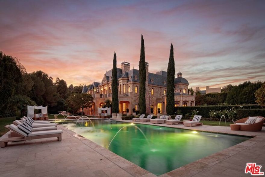 Rarely does an estate of this magnitude & exquisite craftsmanship come to market in the prestigious enclave of Beverly Park. This stunning French Chateau-style estate designed by Richard Landry, AIA features grand scale, opulent finishes, imported materials & every luxury amenity imaginable. Sited on 2+ acres of meticulously landscaped grounds, this compound features a Moroccan themed movie theater, elevator, ballroom, tennis court, & indoor pool & spa complete with treatment rooms, sauna & steam-room. The enormous master suite is truly fit for royalty and features an expansive terrace, soaring ceilings with intricate crown molding, & well-appointed dual closets & bathrooms. Built with the highest standards, the ornate wood paneled office & library features a glass floor that reveals a 2500 bottle wine cellar below. This is a once in a lifetime opportunity to live in what many consider to be the most exclusive guard gated community in the country. Living sq. ft. provided by PlanOmatic.