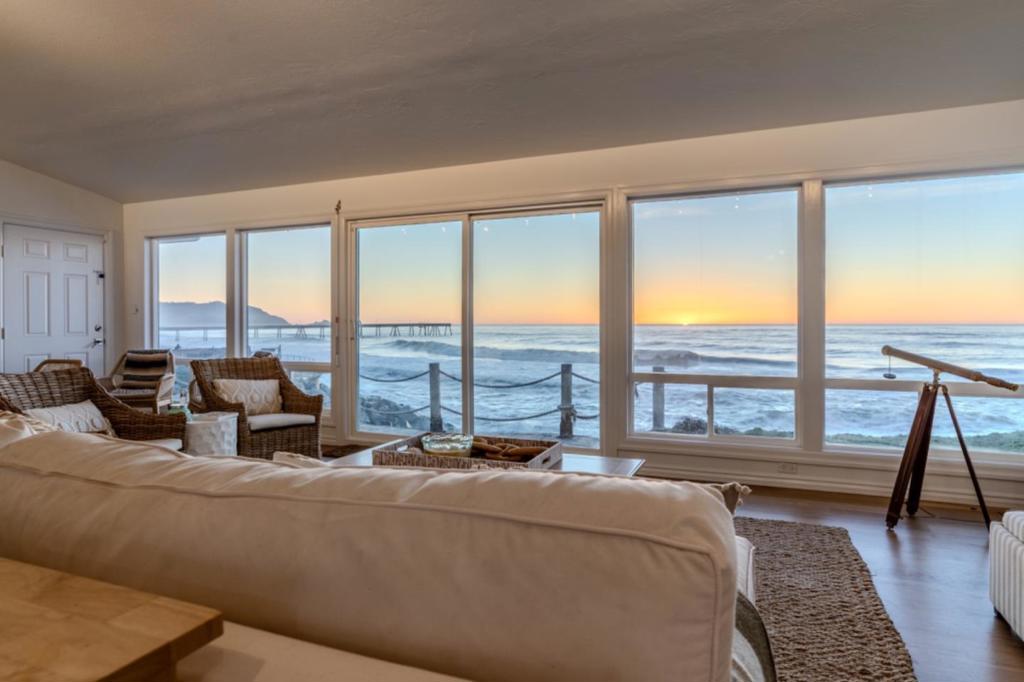 This coastal sanctuary has been meticulously transformed with premium upgrades, designed to provide unparalleled comfort and safety for your family. Every detail reflects thoughtful care and quality, ensuring a home that feels as exceptional as its location. Perched along the scenic Pacific coastline, this two-bedroom, two-bathroom retreat offers a front-row seat to natures grandeur. Enjoy awe-inspiring views from the living area and primary suite, where whales and wildlife can be spotted against the ever-changing seascape. Just moments away, you'll find the iconic Pacifica Pier, celebrated local restaurants, and endless outdoor adventures. San Francisco International Airport and the vibrant city are a short drive away, offering both tranquility and convenience. Inside, modernized bathrooms and an updated kitchen showcase high-end finishes, while new hardwood floors add warmth and elegance. Recent upgrades include a new roof, new furnace, and hardy board siding, ensuring lasting quality and year-round comfort. Automated storm covers provide added security and style, while a versatile garage space adapts seamlessly to your lifestyle needs. This is more than a homeits a coastal masterpiece where every moment feels extraordinary.