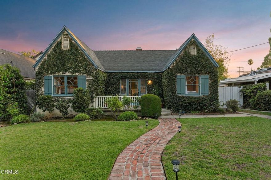Plucked from the pages of a fairytale, 1956 Layton Street makes an enchanting first impression with its white picket fence, English cottage architecture, and ivy-draped facade. The home's storybook charm continues inside where light-filled common areas, a tranquil primary suite, and a picturesque backyard with potential ADU space create a setting as inviting as it is livable. Thoughtful details, like richly toned hardwood floors and coved ceilings create a classic elegance that elevates your daily rituals. The living room includes a handsome fireplace and offers peaceful front yard views while, at the heart of the home, the family room opens onto the backyard and offers a natural setting for connection. In the kitchen, stainless steel appliances and a gorgeous Bertazzoni stove invite you to channel your inner chef. Attached, the dining room welcomes everything from afternoon snacks to joyful dinner parties. After a long day, unwind in the spacious, sunlit primary suite, complete with a generous walk-in closet, backyard views, and an indulgent soaking tub. The private garden backyard offers the sweet smell of blooming roses and is shaded by mature fruit trees. This is a magical place for celebrations, summer barbecues, and peaceful time outdoors. Amidst the greenery, the converted garage space could also serve as a creative studio, home office, or gym. Nestled on a quiet street near the charming shops and restaurants along Washington Blvd, 1956 Layton St offers a beautiful setting to enjoy life's next chapter in a beautiful pocket of Pasadena.