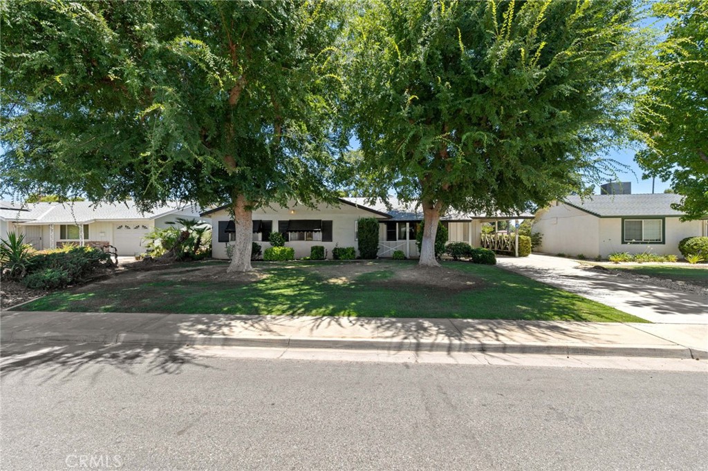 Welcome to this delightful 3-bedroom, 2-bath home in Kern City’s 55+ community—1,613 sq. ft. of turnkey space ready for you to move right in! Enjoy charming neighborhood views through the large front window. Freshly painted walls and updated neutral carpet create a comfortable setting with seamless flow into the kitchen. Bright and inviting, the kitchen area offers a charming blend of vintage character and functionality. The spacious layout includes a full wall of built-in glass-front cabinetry, perfect for displaying your favorite dishware or collectibles. Clean white tile countertops, a breakfast bar, and plenty of prep space make the kitchen both practical and welcoming. The primary bedroom features not one, but two closets, giving you ample room for storage and helping keep your space organized and clutter-free. Step outside to a covered backyard patio, an ideal spot for reading, relaxing, or entertaining—while taking in views of the golf course just beyond your yard.