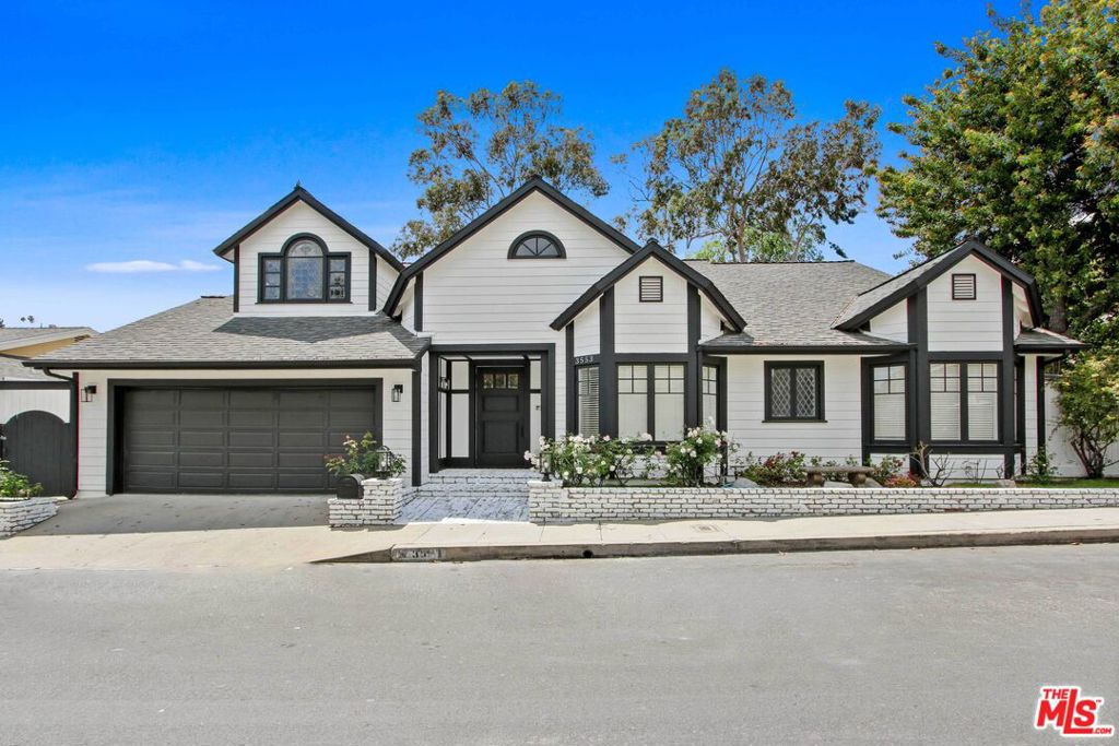 Enjoy breathtaking sunsets and sweeping serene and panoramic views of the Sherman Oaks Hills from this gorgeous 4 beds + 4 baths + Office New England Farmhouse Revival perched on the commanding Cody Road ridge 5 minutes from Downtown Sherman Oaks and conveniently located just a hop and skip away via Mulholland Drive to LA's Westside. This ultra-spacious 3500+ sqft 2022 designer refreshed delight will wow you with its interior volume and expansive wrap-around backyard terrace! Very bright and airy, this home boasts grand 2-story living areas with exposed wood beams, paneled walls, hardwood floors, multiple skylights that bring natural light in, and ultra-charming detail like custom leaded arched windows. As you enter the foyer, you're immediately greeted with outdoor views across the living room with large and tall framed windows exposing the blue sky and the hills beyond. The modern kitchen features a large peninsula perfect for casual family gatherings, opening up to the dining area with views. Retreat in the primary bedroom suite again with views, cozy up by its own fireplace, and breathe with its over 9' ceilings with exposed wood beams and direct access to the backyard terrace. Two extra guest suites and 2 bathrooms complete the first level. At last, up the beautiful circular wooden stairs brings you to an expansive 4th guest suite level complete with an enormous bedroom, bathroom, and a large open mezzanine perfect for an executive office, library, or at-home gym. This emotional residence is located a short drive up from the best of Ventura Blvd conveniences including Whole Foods & The Galleria, about 5 minutes to LA Freeways, and strategy located for access to many of LA's best private schools. 2 car garage with storage & workshop. Come live in this spacious & peaceful oasis of nature! PHOTOS VIRTUALLY STAGED, rented unfurnished.
