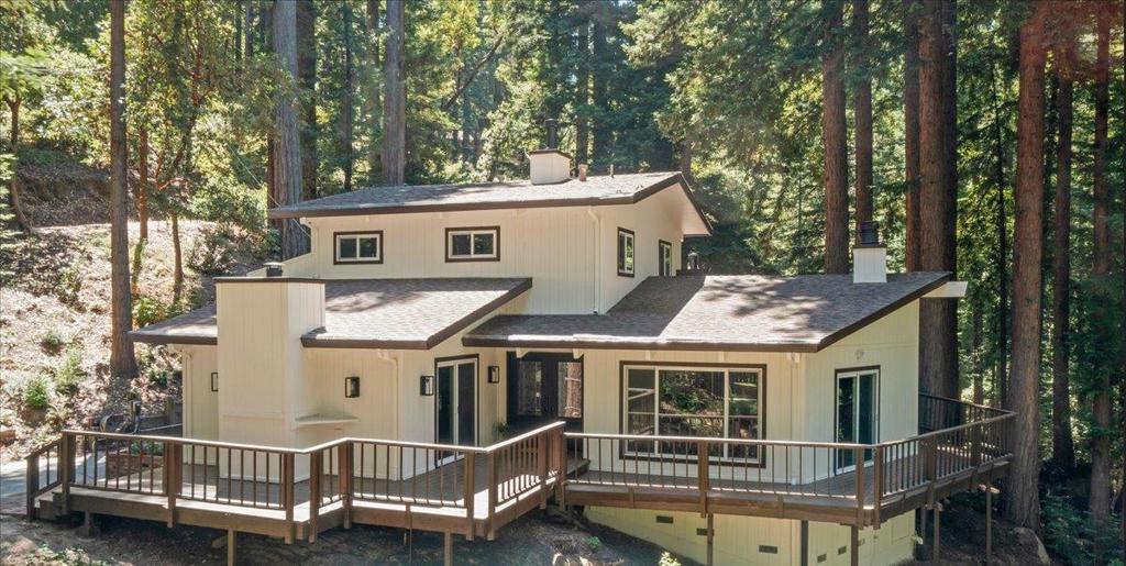 Serene Mountain Retreat with Thoughtful Updates & Modern Amenities. Ideally located just minutes from top-rated schools, the Summit Store, and Soquel Demonstration Forest, this meticulously updated home offers both tranquility and convenience. Every detail has been carefully crafted with high-end materials and finishes, including Lutron smart switches, new windows, new flooring, and a Trane HVAC system. The gourmet kitchen features a gas cooktop, spacious pantry, breakfast bar, and dining area, perfect for entertaining. The expansive living room includes vaulted ceilings, a cozy fireplace, and access to a wrap-around deck that invites indoor-outdoor living. The main level offers two bedrooms, including one ensuite, plus an additional full bathroom. Upstairs, the luxurious primary retreat features a beautifully remodeled bathroom, wood stove, and a private deck with peaceful views. Additional features include a separate workshop with water and electricity (possible ADU potential), two ChargePoint EV chargers, and Frontier Fiber Internet. Fenced yard. Served by award-winning Loma Prieta Elementary, C.T. English Middle, and Los Gatos High School.