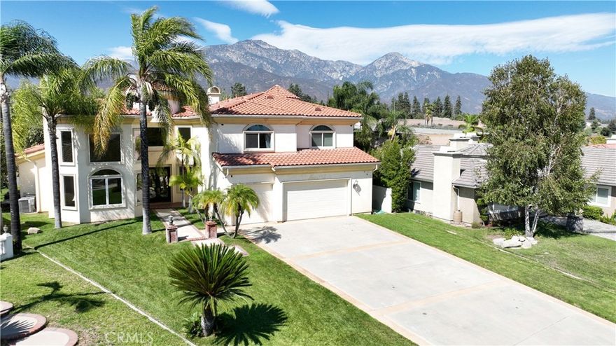 This stunning Mediterranean designed home features stucco walls, red-tile roofs, arched doorways, wrought iron details, and warm, earthy color palettes. An aesthetically impressive and visually appealing residence with high-end finishes, elegant details and a remarkable overall appearance. The home was completely rebuilt in 2009 and consist of 5,617 square feet of living space. When entering through the designer glass & wrought iron entry doors, you are instantly taken back by the marble flooring, Venetian plaster, 20' ceilings, custom chandeliers & staircase with wrought iron railings. This estate home features 6 bedrooms with 6 baths. It's ideal for accommodating large families or multiple guests. You'll enjoy the huge living room with massive high ceilings and warm fireplace. Formal dining room large enough to host dinner parties and holiday feast. Adjacent to the entry you'll find the massive family room with fireplace and open to the kitchen. The kitchen is a chef's delight with an abundance of kitchen cabinets, granite counters, built-in commercial grade stainless steel Thermador appliances and large center island for entertaining your family and guests. On the main floor you'll find 3 bedrooms with a secondary primary suite and bath, that includes a walk-in shower, closet and jacuzzi tub. Upstairs you'll find 3 additional bedrooms including the master suite. The sprawling master bedroom includes a two way fireplace, sitting room, EnSuite bath with walk-in closet, shower, separate tub, dual sinks with designer sinks and fixtures. The long driveway will accommodate multiple vehicles and the rear yard is ideal for entertaining. Overall, this estate is very luxurious, and beautifully designed with Mediterranean architectural charm and ample space for comfort!