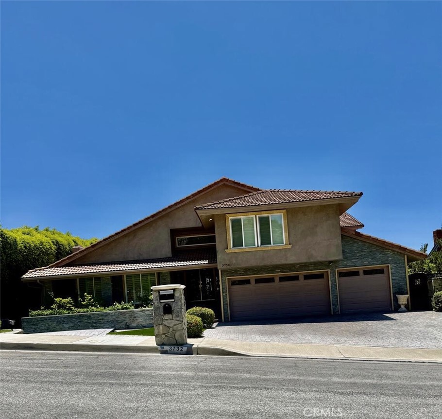 Spectacular Summit View Home above the cities!!! Majestic home has beautiful paver driveway and sidewalks, glass designed double front doors entering this luxury and spacious floor plan. Step down living room with vaulted ceilings and a sunken custom seating area with a gas fireplace for peaceful moments. Formal dining room has a view. Property has no obstructive views! Enjoy daily sunsets, Disneyland fireworks and city lights at your own resort home. Amazing large balcony above the main backyard like no other!!! Relaxing at this elevation away from hectic life. Pristine condition home freshly painted interior. Many features updated in the past few years and remodeled bathrooms and upstairs balcony with new clear viewing glass enclosure. Three fireplaces. Outdoor living space has custom stone pathways, artificial turf and has been created to feel as if you are on a forever vacation & small bathroom (unpermitted). Sparkling salt water pool w/waterfalls and spa above pool for views of city. Custom outdoor living area has built in bbq, island bar seating, refrigerator, television & sound system off of family room. Master Suite has two floor levels, with fireplace, massive bathroom with soaker tub and window to enjoy view. Master suite has it's own huge outdoor balcony/deck enclosed with clear low fencing material facing south toward the ocean, sunsets and fireworks, with a built in bar!!Upper Master Suite level can be for your bed or living room style sitting area. Some models have opposite design and have living and relaxing seating on lower level in front of Master Suite gas fireplace. Custom railing in master for easy access to upper level area recently installed. Expansive walk in closet in Master Suite, Custom Shutters made and installed throughout. Brand new electric stove top & hood in kitchen with stainless appliances. Great granite island for serving and entertainment which seats four more friends. Quality flooring throughout home, with high end carpet in bedrooms and stairway with marble flooring in main areas. Exquisite custom built bar in family room is a must to see!!!! So many features of this home must be enjoyed in person. Two bedrooms on top floor are large and share a spacious renovated bathroom with tub and shower. Additional bathroom off of family room has large tub and separate remodeled shower. Custom cabinetry throughout home built in each room and closets. Plantation shutters in all bedrooms. Unobstructed Views!!!!