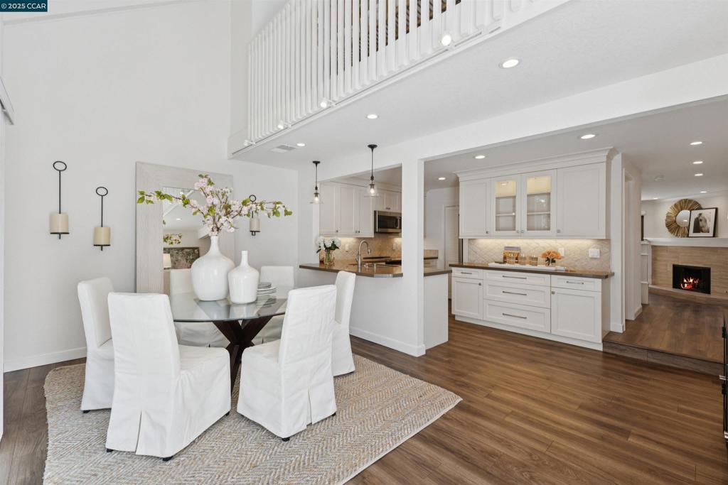 Perfectly situated in a small, sought-after complex, 7 Songbird Ct offers a rare blend of modern updates, abundant natural light, and unbeatable location. This beautifully remodeled two-story residence has been thoughtfully refreshed from top to bottom, featuring luxury vinyl flooring, fresh interior paint, recessed lighting, and updated kitchen and baths. The open-concept kitchen is both stylish and functional, showcasing crisp white cabinetry, a quartz slab countertop, decorative natural stone backsplash, and a walk-in pantry. Laundry is conveniently located nearby. The formal dining area easily accommodates guests and flows seamlessly into a versatile sitting area with sliding doors to the private, newly landscaped back patio. The spacious living room, anchored by a cozy fireplace, opens to the charming front courtyard—complete with extra storage space. Upstairs, all bathrooms have been tastefully renovated in a fresh, neutral palette, ready to complement any style of décor. Additional highlights include central air conditioning & two covered carports. The location is unmatched—just a short stroll to Trader Joe’s, Diablo Foods, and an array of dining options from sushi to Mexican to pizza. Outdoor enthusiasts will love the Lafayette Reservoir offering many outdoor activities.