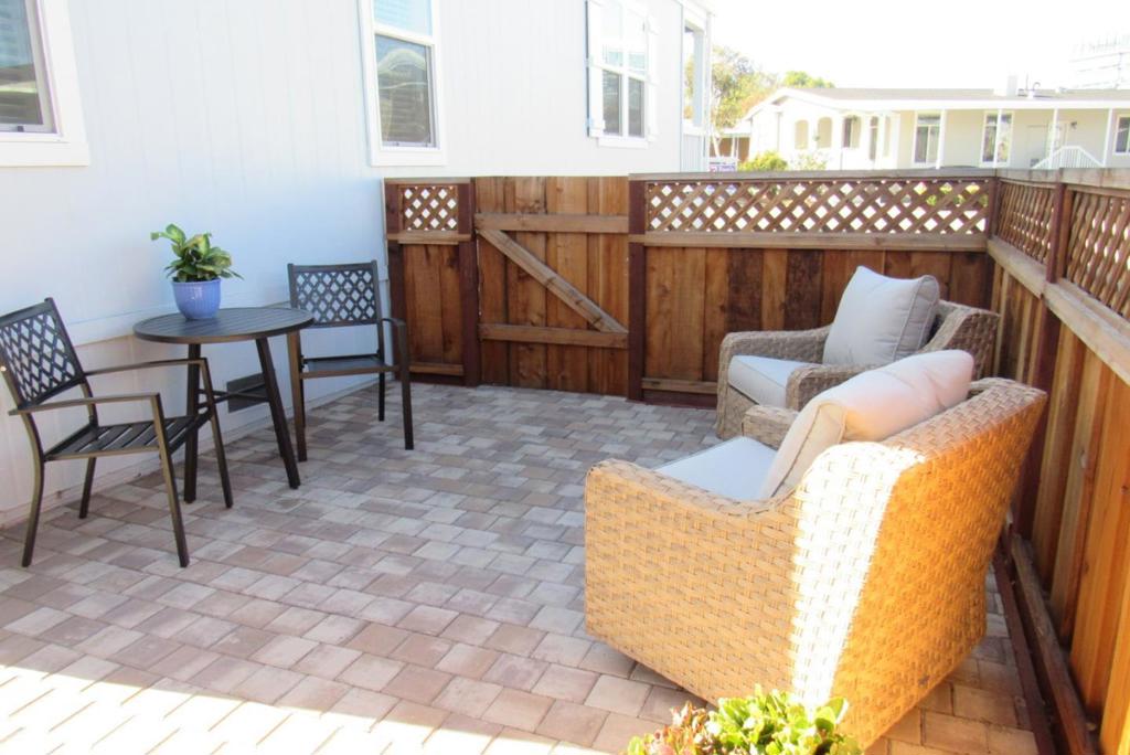 This is a senior 55+ park. MUST SEE! GORGEOUS Like new home with multiple upgrades since purchase, including vinyl wood laminate flooring, fenced-in yard, huge paver patio/walkways, and custom landscaping. The large fenced-in, pavered backyard and a 5-car driveway are a rare commodity in a mobile home park. This home features a split floor plan with an open living concept. Luxury amenities include quality laminate flooring throughout the home, dual pane windows, ceiling fans high 9' tray ceilings, crown molding, and recessed can lighting. The living room boasts a recessed fireplace that provides both ambiance and warmth. Beautiful chef's kitchen with commercial-grade stainless steel appliances, built-in microwave, a large island with sink, and upgraded quartz countertops. The main bedroom includes a large walk-in closet, a private bath with dual vanities, and a spacious walk-in shower. The laundry room comes with hookups. The perfect front porch to sit and relax; having your morning cup of coffee. 2022 Skyline S/N 23700PH001135A/B