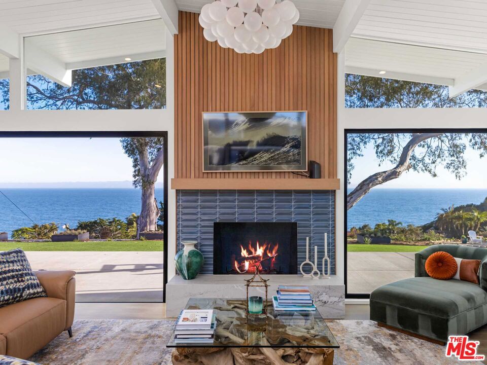 With captivating and unobstructed views of the blue Pacific and Channel Islands beyond, this completely renovated mid-century modern home is situated on over one acre on the much coveted Sea Cliff bluff. The owners commissioned Anacapa Architecture to reimagine this classic gem, maintaining its original classic lines while bringing it into the modern-age by adding functionality with an open flow, luxurious amenities, and only the finest designer finishes. Upon entering the entrance courtyard, one is immediately greeted by awe-inspiring views through the custom iron pivot front door. The open plan living room, dining room and kitchen have been reoriented for seamless indoor/outdoor living via La Cantina stackable doors, beckoning to the outdoor patio which spans the length of the house. Enjoy the views while creating culinary delights in the chef's kitchen with a 6 burner Viking range, custom white oak cabinetry, quartzite countertops and an 11' island with counter seating. The primary suite enjoys ocean vistas and along with a zen spa bathroom with a freestanding tub, Brizo fixtures, both indoor and outdoor showers, and garden views. Adjoining the bathroom is a large boutique-style walk-in closet with multiple built-ins. The outdoor areas include a large entertainment patio, newly planted landscaping, a firepit area, raised planters, storage shed, an avocado orchard, Meyer lemon, plum, and grapefruit trees. Additional amenities include a large laundry room and dedicated storage area. A rare opportunity for the buyer looking for unprecedented ocean views, privacy, and high style architecture and design.