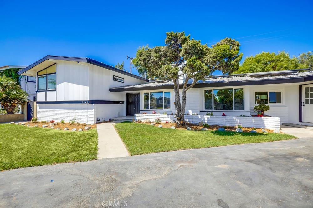 Welcome to 2543 E Ames Avenue, a beautifully updated residence tucked at the end of a cul-de-sac in Anaheim. Blending fresh modern upgrades with timeless character, this spacious home offers versatile living areas, a resort-style backyard, and a prime location for comfortable Southern California living.
The exterior showcases a crisp new paint job with white siding and black trim complemented by new windows, fresh landscaping, and a long driveway leading to a brand-new garage door. Solar panels add energy efficiency, while a bold black front door sets the tone for the stylish interior.
Inside, the freshly painted home features refinished hardwood floors and a bright, welcoming layout. The formal living room greets you with a cozy fireplace, vaulted ceilings, and white wood beams. The updated kitchen includes all-white cabinetry with sleek black hardware and fixtures, flowing into a formal dining room illuminated by a modern black chandelier. A spacious family room with a second fireplace and dual glass sliding doors, creating seamless indoor-outdoor living. Off this area, you’ll also find a laundry room, an additional bathroom, direct garage access, and a side entrance for added convenience.
The backyard is a true retreat—complete with a sparkling repainted pool featuring a diving board, slide, and decorative lava rock accents. An in-ground spa, built-in firepit, and expansive wraparound yard with mature trees, paved areas, and storage sheds make it perfect for entertaining or relaxing year-round. A private exterior entrance also leads to a versatile fourth bedroom, ideal as a guest suite, office, or workout space.
From the main entry, two staircases provide thoughtful separation of the living spaces: the lower level leads to the additional bedroom with its private entrance, while the upper level features two secondary bedrooms with fresh paint, new windows, and updated flooring. Linen closets line the hall, which also connects to a fully renovated bathroom showcasing sleek black-and-white finishes, new fixtures, and upgraded electrical. The primary suite completes this level, offering a serene street-facing view, its own private bath, and a sliding closet—all refreshed with the same modern updates.
With a paid-off solar system, updated electrical, fresh finishes throughout, and a flexible multi-level floor plan, 2543 E Ames Avenue is a move-in-ready home with character, functionality, and modern efficiency—all in a quiet cul-de-sac location
