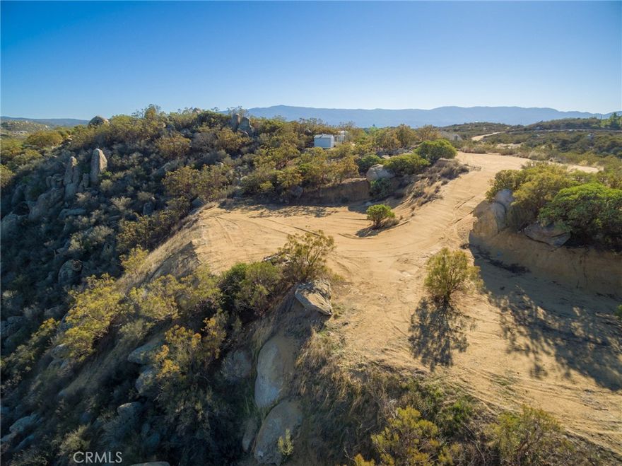 Come enjoy the beautiful views from this 2.7 +/- acre privacy pocket, at the end of a cul-de-sac, within the highly appointed gated community of Lake Riverside Estates. 
A short drive SE of Temecula will bring you to this hidden treasure of custom homes and lots on about 2.5 acres, surrounding a lake, landing strip, pool, horse facility, meeting room, fire department/EMT, and maintained roads. 
Perfect for the destination venue of your personal retreat, bring your plane, horse, fishing pole, keyaki, and walking shoes to enjoy all the amenities this lot and its community has to offer.
Seasonal creek.
Needs well, power at street.
Seller willing to carry.