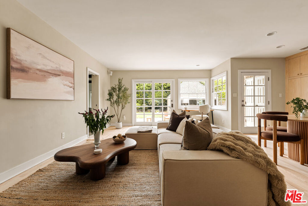 In the heart of Los Angeles' storied Brookside enclave, this refined English-style residence exemplifies timeless elegance and modern sophistication. Beyond its picturesque facade, the home reveals an open-concept floor plan complete with original architectural details and a graceful flow between living spaces. The formal living room, anchored by a charming statement fireplace, is bathed in natural light from oversized windows framing serene views of the neighborhood's verdant, tree-lined streetscape. A newly remodeled kitchen showcases craftsmanship and style, featuring exquisite countertops, bespoke cabinetry, and stainless-steel appliances. Designed for effortless indoor-outdoor living, the adjoining family room opens to an expansive private garden, complete with manicured lawn, generous hardscaping, and multiple settings for alfresco dining and grand-scale entertaining. The sumptuous primary suite offers a private sanctuary with a luxurious ensuite bath, while two additional bedrooms and an upstairs bonus room provide exceptional versatility for guests, work, or leisure. Ideally situated in one of the city's most walkable neighborhoods, this residence enjoys a rare balance of tranquility and proximity just moments from the acclaimed boutiques, cafes, and cultural charm of Larchmont Village.