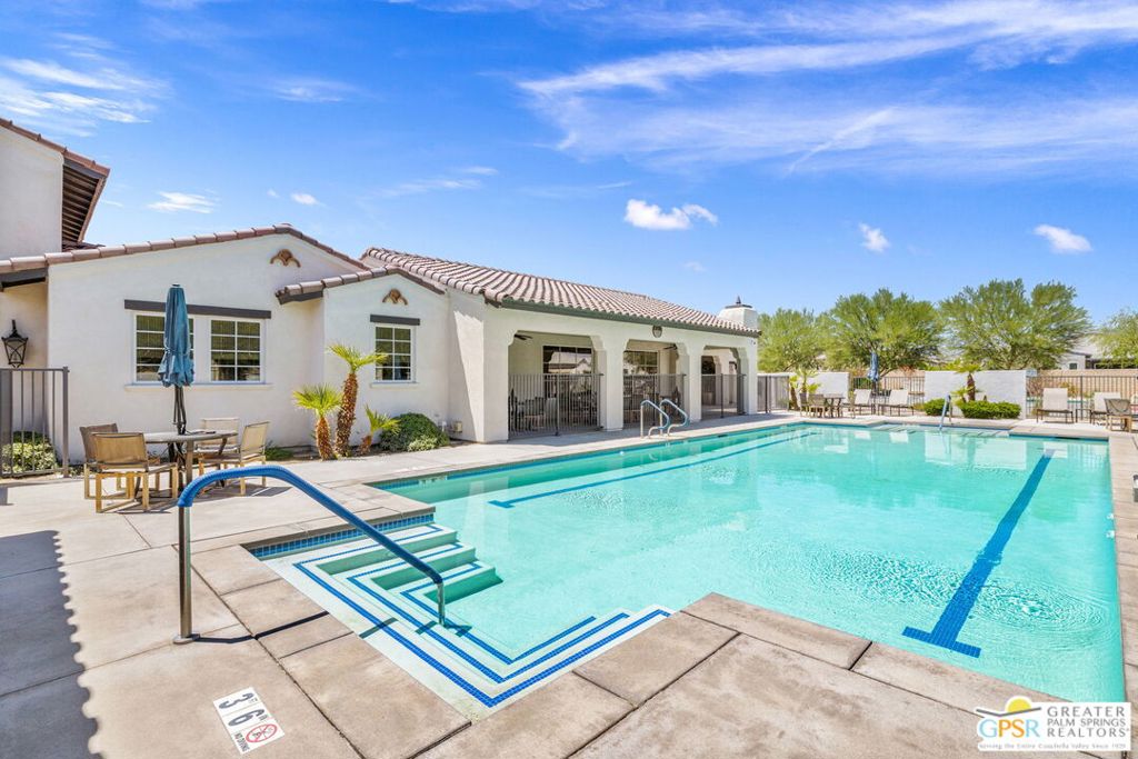 WOW! Check out this thoughtfully designed 3 bed 3 bath home that blends comfort, style, and easy living behind the gates at Domani, a 55+ community in Palm Desert that offers resort-style amenities! Tall ceilings, open floor plan and a great separation of bedrooms! The kitchen is a standout with granite slab counters, island seating, clerestory windows, under-cabinet lighting, and a walk-in pantry. The dining area flows to a spacious covered patio and private backyard, upgraded with rain gutters, irrigation, and desert-wise landscaping. The primary suite offers a tiled walk-in shower with clerestory window and bench, dual vanities, a walk-in closet, and a separate water closet. Junior Ensuite Two has an ensuite bath. Bedroom Three has a nearby bath. Large utility room with built-ins adds convenience. A two-car attached garage rounds out the package. Enjoy low HOA fees and resort-style community amenities including a 5000 sq ft clubhouse with gym, office, kitchen, and game room, plus a pool and spa, outdoor fireplace, bocce ball, pickleball, a gated dog park, and front yard maintenance. The best of Palm Desert's shopping, dining, and golf is just a short hop away. Take the Matterport Virtual Tour and explore the lifestyle waiting at Domani.