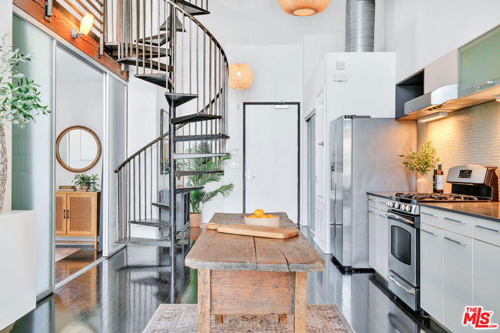 Experience elevated living in this top-floor 2BD/2BA loft-style unit in Marina del Rey, featuring a private rooftop deck with 360 city and marina views. Soaring 17' ceilings, floor-to-ceiling windows with automated shades, and rich bamboo flooring create a stunning industrial-modern aesthetic. A bonus loft provides flexible space for a home office, gym, or studio, while an additional flex area offers the option to enclose and create a 3rd bedroom with a walk-in closet. The open-concept layout includes a cozy gas fireplace and a chef's kitchen with high-end stainless steel appliances and custom cabinetry. Enjoy two dedicated parking spaces with EV charging, ample guest parking, and an unbeatable location in one of Marina del Rey's most walkable neighborhoods just minutes from shops, dining, entertainment, and the beach. HOA includes water, trash, building insurance, and common area utilities.