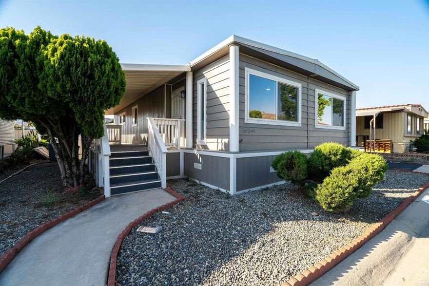 LOVELY REMODELED HOME COMPLETE WITH FENCING. OFFERED FOR $269,000.  This must-see home sits in a Senior Community for ages 55 and above.  Mission Village has many amenities including a heated pool and Jacuzzi, a gym, a laundry room, and a clubhouse for social gatherings.  This home has been given a complete make over including a new roof, a new water heater, new decking for the porch, new white vinyl fencing, new washer and dryer, new kitchen appliances, new cabinets for both the kitchen and baths, new vinyl laminate flooring all throughout the home, plus more.  It is in a great location, just across the street from the clubhouse.  The monthly space rent here is 1,425.00.  If you are looking for a nice relaxing Senior home that is move in ready, you do not need to look any further.  This home is for you!!