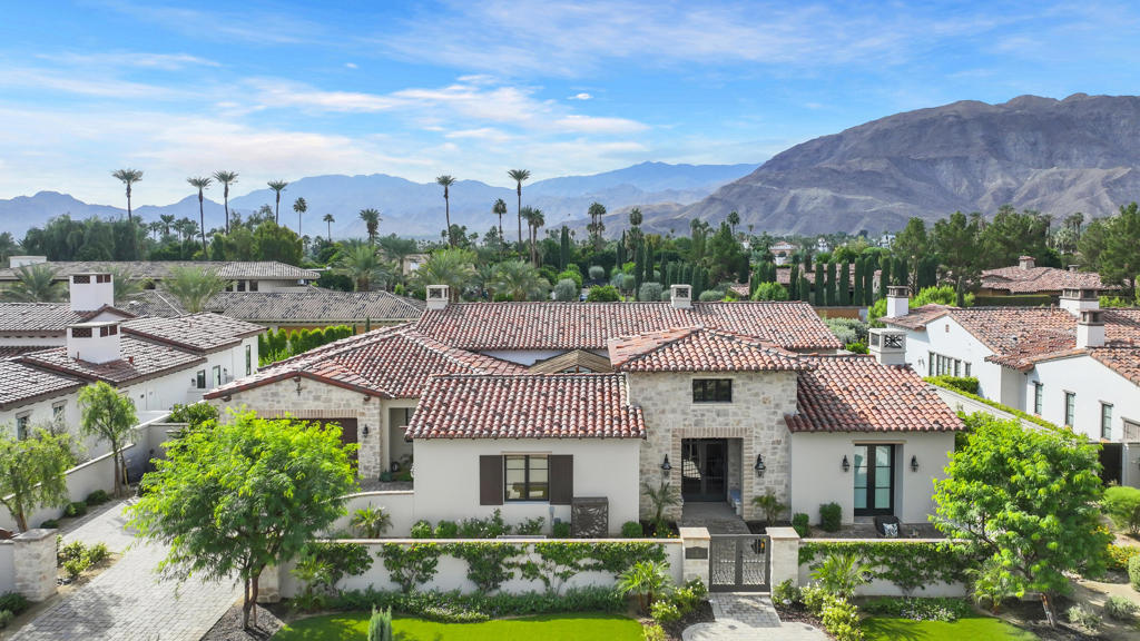 Only minutes away from El Paseo, The River and the new Disney Cotino development, hidden behind the gates of Bella Clancy this home is on a prime cul-de-sa lot with stunning views of the southern mountains, the Best in Bella Clancy. Old world charm of a Tuscan Villa! the owner spared no expense with the custom designer upgrades. From start to finish every detail of each room was being transformed into a visual delight, like a piece of art. This smart home intergrates the latest entertainment, security and convenience technologies. There are 5 bedrooms and 5.5 bathrooms. The primary suite is situated to allow privacy separated from the addional 4 ensuites. With 4,864 SF there is plenty of room for family and friends. The Great Room with a generous dining area allows for many gatherings small or large. The kitchen is a ''true'' chef's delight with upgraded appliances including a built-in wine refrigerator, quality cabinetry and gorgeous slab Quartzite countertops with sit-up island and a cozy breakfast area with built-ins that is adjacet to the backyard. The front gated courtyard entry prepares you for many delights of outdoor living. From the secluded sitting area with overhead trellis that is situated with easy access to the interior with large glass sliders. The backyard has lush landscaping that includes various citrus trees and an inviting custom pool with spa. And the View...Truly Spectacular morning or evening! The great room has tall soaring pocket sliders that allows the view to be seen from inside. There are custom balustrades that adds a coziness to the large covered patio that includes a visually inviting fireplace and convenient BBQ area.There are two separate 2/car garages. The owner has creatively used one garage as a family/friends/owner entertainment room with a mini-split air conditioner and walls of custom cabinetry. This can easily be converted back to garage usage. This property is truly a dream home with a great location. convenient to easy freeway access, hospitals and shopping centers close by.