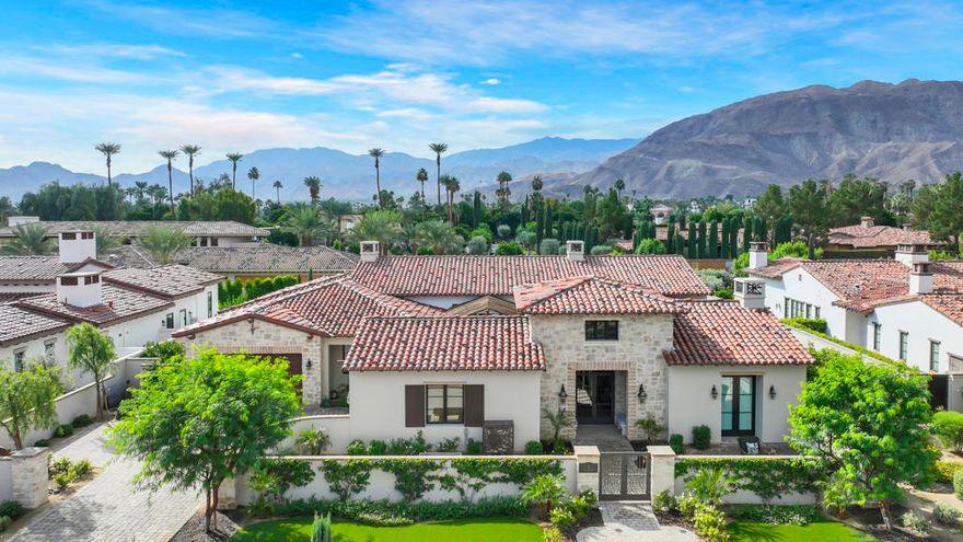 Only minutes away from El Paseo, The River and the new Disney Cotino development, hidden behind the gates of Bella Clancy this home is on a prime cul-de-sa lot with stunning views of the southern mountains, the Best in Bella Clancy.  Old world charm of a Tuscan Villa! the owner spared no expense with the custom designer upgrades. From start to finish every detail of each room was being transformed into a visual delight, like a piece of art. This smart home intergrates the latest entertainment, security and convenience technologies. There are 5 bedrooms and 5.5 bathrooms. The primary suite is situated to allow privacy separated from the addional 4 ensuites. With 4,864 SF there is plenty of room for family and friends. The Great Room with a generous dining area allows for many gatherings small or large. The kitchen is a ''true'' chef's delight with upgraded appliances including a built-in wine refrigerator, quality cabinetry and gorgeous slab Quartzite countertops with sit-up island and a cozy breakfast area with built-ins that is adjacet to the backyard.  The front gated courtyard entry prepares you for many delights of outdoor living. From the secluded sitting area with overhead trellis that is situated with easy access to the interior with large glass sliders. The backyard has lush landscaping that includes various citrus trees and an inviting custom pool with spa. And the View...Truly Spectacular morning or evening! The great room has tall soaring pocket sliders that allows the view to be seen from inside. There are custom balustrades that adds a coziness to the large covered patio that includes a visually inviting fireplace and convenient BBQ area.There are two separate 2/car garages. The owner has creatively used one garage as a family/friends/owner entertainment room with a mini-split air conditioner and walls of custom cabinetry.  This can easily be converted back to garage usage. This property is truly a dream home with a great location. convenient to easy freeway access, hospitals and shopping centers close by.