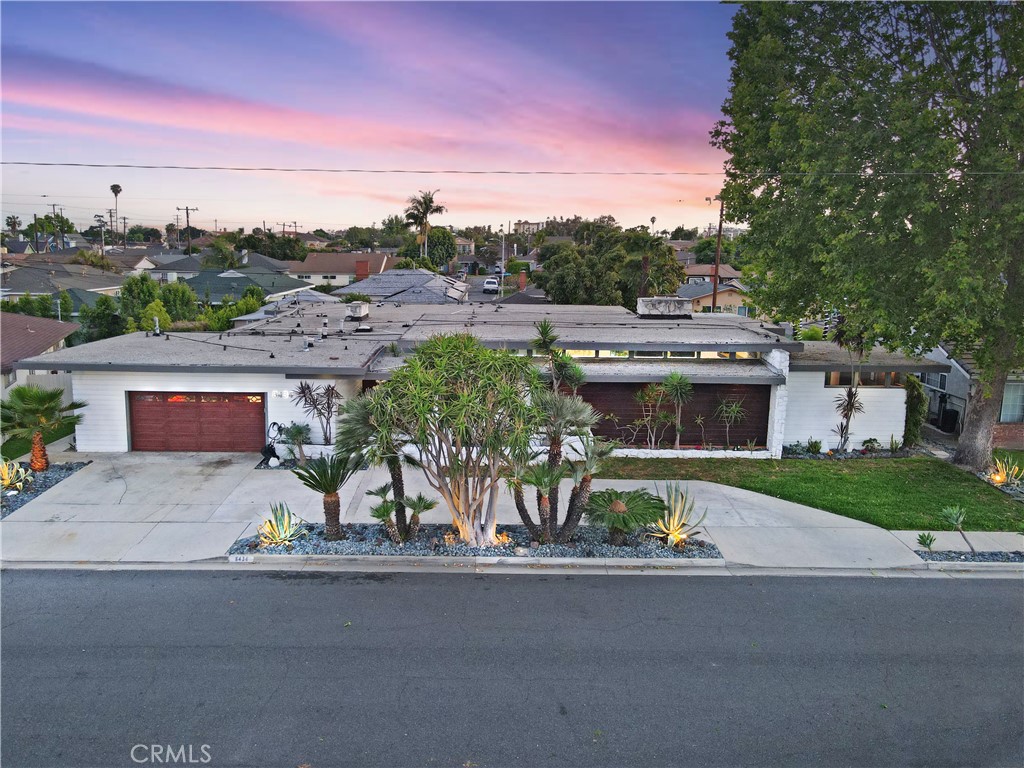 Discover a Spectacular Custom Mid-Century Modern Retreat with Pool in a Prime area of Downey! Nestled in a serene cul-de-sac near the highly sought-after Cherokee Estates area, this exquisitely crafted mid-century modern residence seamlessly merges classic design elements with modern amenities, all while embodying the essence of resort-style living. Boasting 5 spacious bedrooms and 4 well-appointed bathrooms, this home is designed with both comfort and entertaining in mind. As you enter, you are greeted by the impressive sunken living room, where expansive floor-to-ceiling windows invite natural light to cascade in, highlighting the elegant space. Flowing effortlessly from the living room, the open-concept layout features a striking wet bar that creates an ideal hub for gatherings. The updated kitchen dazzles with premium stainless steel appliances, including a modern vented hood that crowns the central island, while the adjacent family room, which offers cozy views of the tranquil pool, features its own inviting fireplace—perfect for intimate family evenings. Retreat to the private primary suite, an oasis designed for ultimate relaxation, boasting direct access to the backyard. The beauty of outdoor living is fully realized in this residence, featuring a meticulously landscaped front yard that embraces drought-tolerant design and showcases an elegant circular driveway accentuated by captivating lighting. Step into the backyard paradise, where the sparkling pool awaits, complemented by a covered patio and a built-in barbecue, allowing for delightful alfresco dining and entertainment. This one-of-a-kind home harmoniously blends custom character with contemporary comfort, placing it in one of Downey’s most desirable neighborhoods—truly a gem for those seeking a unique living experience.