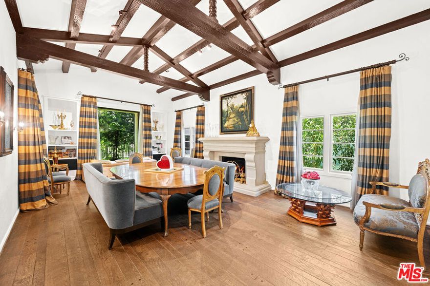 Hollywood Regency Gem in the Heart of Beverly Hills. Step into timeless elegance at this beautifully maintained, authentic Spanish estate, the former home of Jean Harlow!! Located in prime Beverly Hills, this 6-bedroom, 9-bath residence exudes charm, character, and architectural integrity. The spacious den with fireplace opens to a large deck with a retractable awning, perfect for indoor-outdoor entertaining. A saltwater pool anchors the lush backyard, creating a true private oasis. The luxurious primary suite features dual bathrooms, a steam shower, and an expansive walk-in closet. Additional highlights include : A two-story guest house with private balcony. Electric vehicle charger. Gas generator with extra fuel tanks. ADT alarm system with security cameras. Gated and secure for maximum privacy. A rare opportunity to own a piece of local history in one of the most desirable neighborhoods in Los Angeles. Don't miss it!