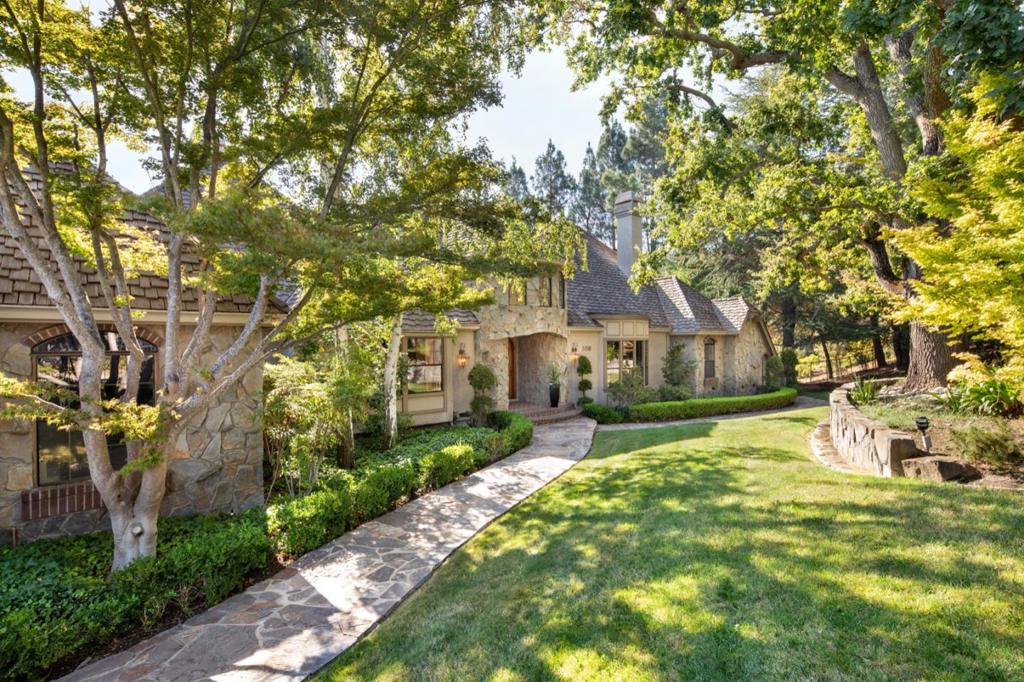 Desirable Silicon Valley retreat with storybook curb appeal. 4 bedrooms + 1 library, 4 full bathrooms, 2 half bathrooms. Nearly 1 acre lot, private & gated. Lush front lawn, magnificent oaks, lovely Japanese maples & on-site walking paths. Thoughtfully-designed floorplan with vaulted ceilings & generous size living, dining & family rooms. Nice kitchen layout with butcher block island opens to breakfast room with walk-out deck overlooking backyard. Hardwood floors. Butler's pantry. Mud room. Well-appointed spacious, romantic primary suite with large fireplace, cathedral ceilings, two walk-in closets & built-ins, shower enclosure, dual vanities & soaking tub. Lower level has spacious guest rooms, including secondary family/game room, secondary suite with adjacent kitchenette, balconies & spa-like sauna. Plenty of storage. 3 car garage with gated motor court for car enthusiasts. Low-traffic cul de sac. Desirable neighborhood adjacent to open space preserve & just steps to hiking trails.