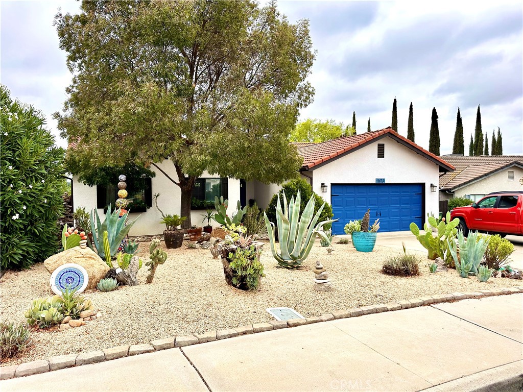 Beautifully remodeled single-level home offers three bedrooms and two bathrooms, blending comfort with modern upgrades. The heart of the house is the remodeled kitchen, featuring updated cabinetry with soft-close doors, beautiful countertops, and a spacious island with breakfast bar seating - perfect for casual dining or morning coffee. A bright dining area flows seamlessly to the large back deck, making entertaining effortless. Both bathrooms have been tastefully updated, and a central air conditioning system ensures year-round comfort. Outdoors, enjoy a huge backyard shaded by mature trees, a brick patio, and a garden area for relaxing or playing. The inviting back deck is ideal for gatherings or quiet evenings. Move-in ready, this home seamlessly combines modern upgrades with the charm of Paso Robles.