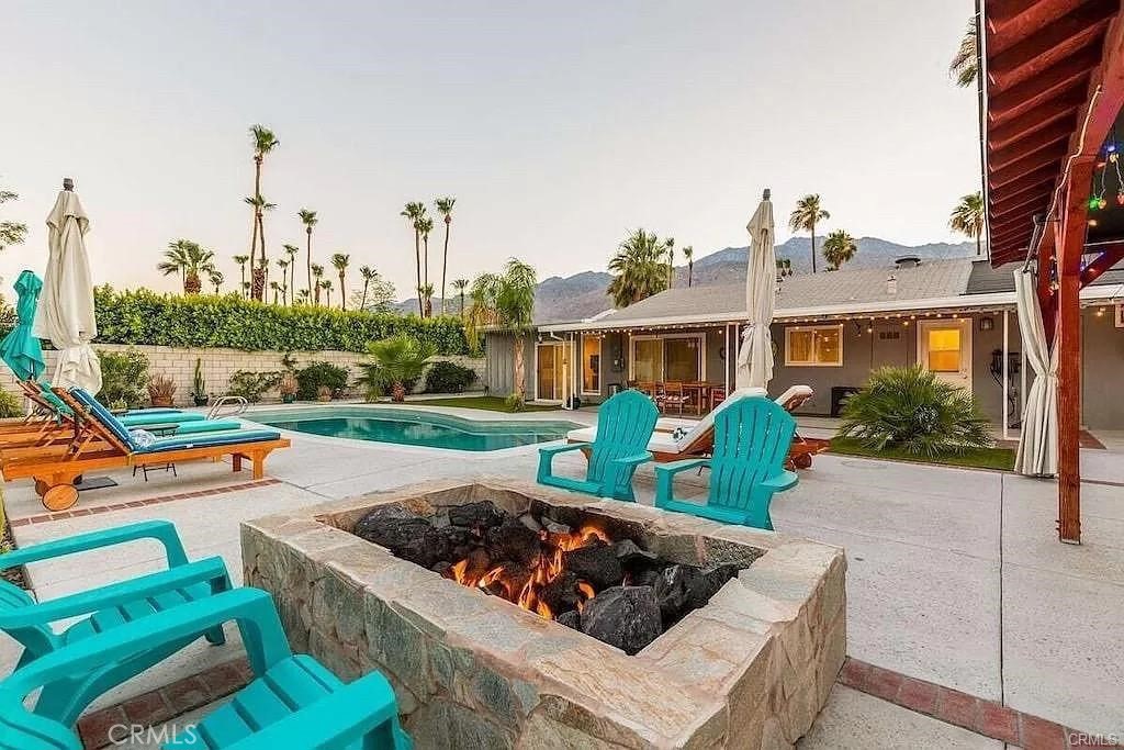Beautiful Alexander style home in a quiet residential neighborhood, centrally located to downtown Palm Springs and many local shops, restaurants and attractions. It sits on 1/3 acre lot with a very spacious yard with private pool , cactus and citrus garden, BBQ, fire pit, large entertainment space with great mountain views. It is located within 5 min drive to downtown PS, 15 drive to Aerial tramway station, 3 min drive to grocery stores and Walgreens, 6 min drive to Casino, convention center. It features a large open concept living room area with a dark laminate floors and a flowing, modern room and contrast beautifully with a grey comfortable sofa and a love seat, and the kitchen has an open floor plan with breakfast bar and featuring dark cabinetry & contrasting white quartz counter tops & stainless steel appliances.
The sliding door from the living room area opens to a very private, large yard with a sparkling blue pool and a garden gazebo great for relaxation and outdoor dining. House can be delivered furnished or unfurnished and the $3900/mo is for the period starting on February 1st, 2026, after this date price to be negotiable.
