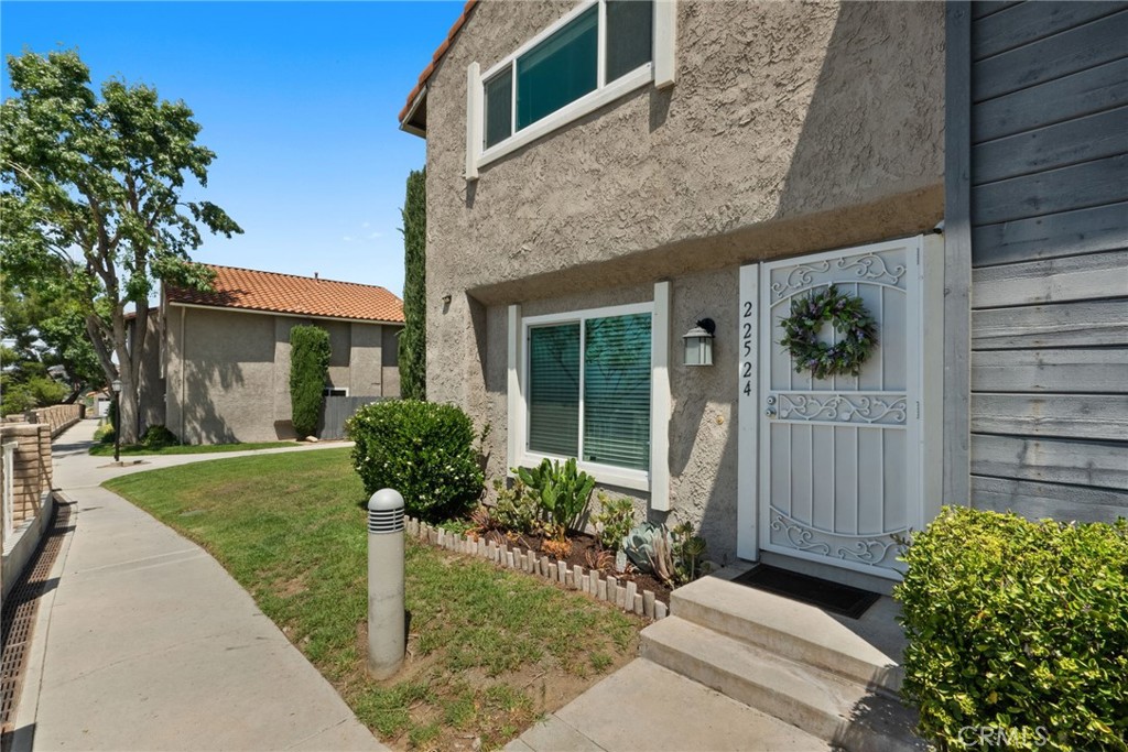 Beautiful Corner Townhome with Scenic Views in Santa Clarita! Don’t miss this exceptional opportunity to own a corner unit nestled next to a tranquil greenbelt, this upgraded townhome offers both privacy and picturesque views. Step inside to discover stylish upgrades throughout, including updated flooring, energy-efficient windows, a newer sliding glass door and recessed lighting that brightens every space. The first floor features a cozy family room with fireplace, kitchen, dining room & convenient guest powder room. Upstairs you’ll find a double-primary bedroom layout—each bedroom is generously sized, complete with ceiling fans and walk-in closets, sharing a bathroom with updated shower enclosure. Entertain with ease in your private courtyard—perfect for summer BBQs and outdoor relaxation. Additional highlights include a private one-car garage, an extra carport, and built-in storage for added convenience. The community offers fantastic amenities, pool, playground, basketball court and is located near award-winning schools, scenic parks, and all the best that Santa Clarita has to offer.