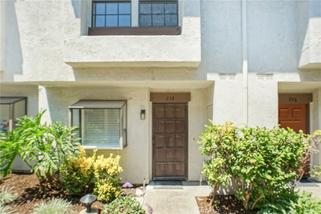 Welcome to the charming gated community of Placentia Lakes, known for its picturesque meandering streams and tranquil surroundings. This rarely available end-unit offers a unique combination of light, space, and convenience, making it a truly special find. Situated just steps from the community pool, spa, and sauna, this property promises a lifestyle of comfort and leisure. As you step inside, you’re greeted by brand-new luxury vinyl plank flooring that flows seamlessly throughout the entire first floor, creating a modern and cohesive look. The dining room features a beautiful sunlit window, allowing natural light to flood the space and highlight the fresh new paint, newly scraped ceilings, and recessed lighting that grace the entire home. The well-appointed kitchen is a true highlight, offering ample counter space, a walk-up pantry, a sunny garden window, and stainless steel appliances. This kitchen is as functional as it is beautiful, perfect for meal preparation and entertaining. Adjacent to the kitchen, the spacious dining room to relax and dine. A few steps down, the living room welcomes you with soaring ceilings, a floor-to-ceiling brick fireplace, and a wet bar for added elegance. The living room also opens to a waterfront patio, perfect for enjoying peaceful outdoor moments. Upstairs, the home features two generously sized bedrooms and two bathrooms. The secondary bedroom boasts an extra-deep closet with mirrored sliding doors and its own private bathroom. The luxurious primary bedroom offers dual closets—one walk-in and one with sliding doors—plus an additional cabinet for linens. You’ll also find a private second-floor patio with serene views of the tree-lined sky, adding a touch of tranquility to your retreat. This home also comes with a one-car garage, its own private laundry room, and convenient community parking, making everyday life a breeze. Residents enjoy access to top-notch HOA amenities, including two community pools, spa, sauna, tennis courts, and a meeting room. Located in the heart of South Placentia, this home is within close proximity to excellent schools, making it the perfect place to call home.