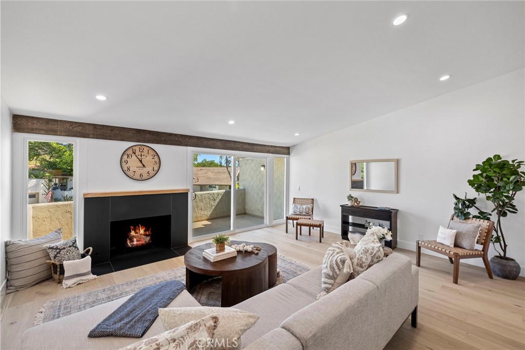 Step into a home where coastal light and effortless elegance define every corner. Nestled in Newport Beach’s desirable Eastbluff community, this beautifully updated townhouse invites you to imagine your life unfolding here — mornings on the balcony with soft sunlight spilling across the living room, evenings gathered around a striking black-tile fireplace accented with rich wood beams, and weekends flowing seamlessly between indoor and outdoor spaces.
The kitchen and dining area are designed for living as much as cooking. Quartz countertops, contrasting cabinetry, and high-end appliances create a space that’s as functional as it is beautiful, while sliding doors open to a covered patio and private landscaped yard where lush turf and greenery offer a serene, low-maintenance retreat. Whether it’s morning coffee, casual lunches, or sunset gatherings with friends, every moment feels effortless and refined.
The primary suite is your private sanctuary. Vaulted ceilings and abundant natural light frame a spa-inspired bathroom with a soaking tub, separate walk-in shower, dual sinks, and custom cabinetry — a place to unwind and start the day rejuvenated. The second bedroom is equally luminous, perfect for family, guests, or a home office, with an adjacent beautifully appointed full bath.
Beyond the home, life in Eastbluff is filled with coastal adventure and convenience. Stroll to the Back Bay trails or take a short drive to nearby beaches like Corona del Mar, Balboa Peninsula, and Crystal Cove. Enjoy the community's amenities of the Newport Beach Tennis Club, Eastbluff Park, Eastbluff Elementary, Corona del Mar High School, a K–8 private school, and the Boys & Girls Club, while your daily errands are effortless with a grocery store, pharmacy, restaurants, and urgent care all within walking distance.
558 Vista Flora is more than a house — it’s a lifestyle. A home where every detail has been crafted to create beauty, comfort, and the effortless enjoyment of everything Newport Beach has to offer. Here, life feels inspired, light-filled, and fully yours.
