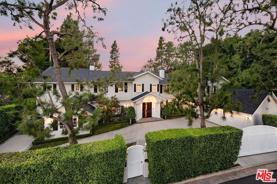 Holmby Hills Gem, Traditional Estate - redesigned and furnished by Steve and Brooke Giannetti. Set behind high gates on just under 1/2 acre of manicured grounds. Soaring 2-story entry hall, with floating staircase. Formal living room with fireplace, wood paneled media room with incredible bar area. All public rooms open via French doors to grassy yard and pool. Gourmet kitchen with adjacent family room. Exquisite primary suite with high ceilings, double marble baths with incredible moldings and large walk-in closets. 5 additional bedrooms. Large 3 car garage. A tree top view - rare for Holmby Hills. Must see! Shown only to prequalified buyers.