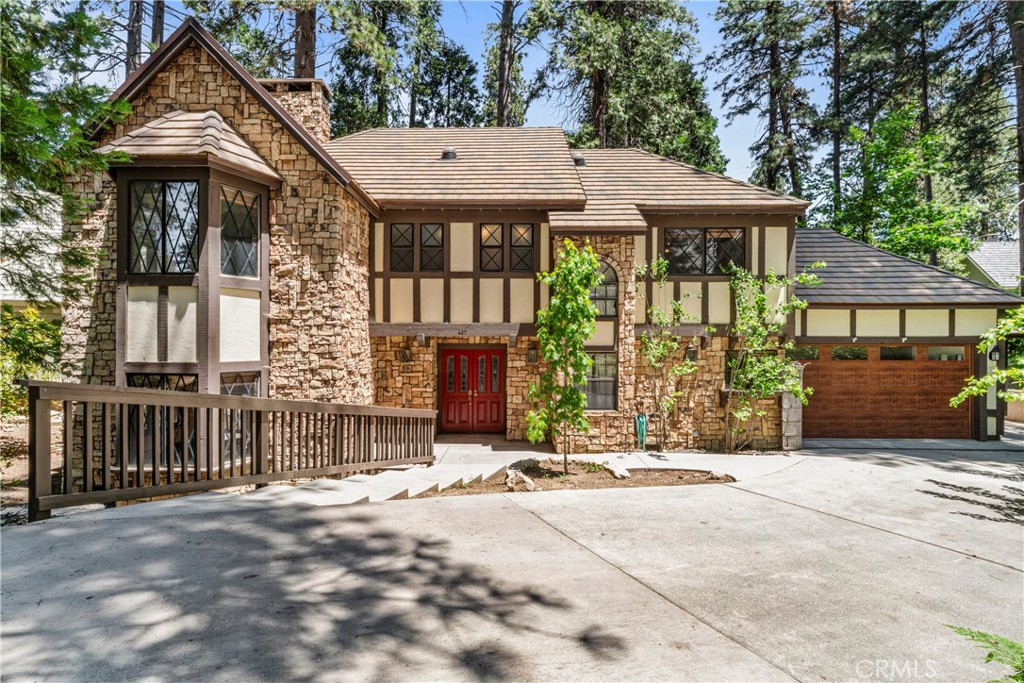 Charming English Tudor in Prestigious Point Hamiltair with Boat Slip on Private Lake Arrowhead
Behind the coveted gates of Point Hamiltair, one of Lake Arrowhead’s most prestigious lakeside communities, discover this timeless English Tudor-style retreat. Tucked at the end of a quiet cul-de-sac, this beautifully updated 3,164 sq ft home offers privacy, charm, and modern amenities in an idyllic setting.
Boasting level entry with an attached 2-car garage, this 4-bedroom, 3-bath residence sits on a private, tree-studded lot surrounded by towering pines, perfect for those seeking serenity and natural beauty.
Inside, enjoy an updated kitchen, wood floors, and a spacious floor plan designed for effortless indoor-outdoor living. The large entertaining deck invites gatherings under the canopy of trees, ideal for summer evenings or morning coffee.
Just a short stroll away is your private boat slip on exclusive Lake Arrowhead, Southern California’s premier private lake community, offering boating, fishing, swimming, and year-round recreation.
Whether as a full-time residence or a luxurious weekend retreat, this exceptional property blends classic Tudor charm with modern comfort in an unparalleled lakeside setting.
