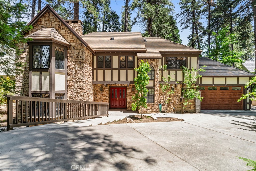 Charming English Tudor in Prestigious Point Hamiltair with Boat Slip on Private Lake Arrowhead
Behind the coveted gates of Point Hamiltair, one of Lake Arrowhead’s most prestigious lakeside communities, discover this timeless English Tudor-style retreat. Tucked at the end of a quiet cul-de-sac, this beautifully updated 3,164 sq ft home offers privacy, charm, and modern amenities in an idyllic setting.
Boasting level entry with an attached 2-car garage, this 4-bedroom, 3-bath residence sits on a private, tree-studded lot surrounded by towering pines, perfect for those seeking serenity and natural beauty.
Inside, enjoy an updated kitchen, wood floors, and a spacious floor plan designed for effortless indoor-outdoor living. The large entertaining deck invites gatherings under the canopy of trees, ideal for summer evenings or morning coffee.
Just a short stroll away is your private boat slip on exclusive Lake Arrowhead, Southern California’s premier private lake community, offering boating, fishing, swimming, and year-round recreation.
Whether as a full-time residence or a luxurious weekend retreat, this exceptional property blends classic Tudor charm with modern comfort in an unparalleled lakeside setting.