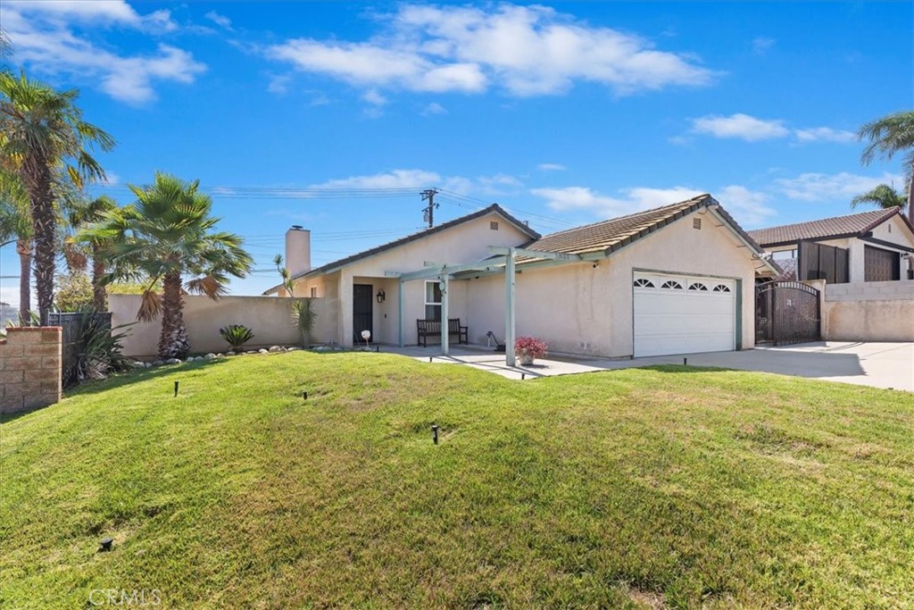 Stop Dreading Your Electric Bill —This solar-equipped single-story home is designed to keep energy costs low, thanks to approximately 16 seller-owned solar panels. Step inside to high ceilings and travertine tile that flows throughout the main living areas. The family room features a fireplace, while the kitchen offers granite countertops, a pantry, stainless steel appliances, and a separate dining area. This 4-bedroom, 2-bathroom home spans approximately 1,540 square feet and includes an indoor laundry area for added convenience. Energy-efficient upgrades include a 200-amp electrical panel, tankless water heater, and a newer Lennox HVAC system with updated ductwork for enhanced performance. You'll also find ceiling fans and recessed lighting throughout the home. The backyard offers plenty of space and potential — whether you're dreaming of custom landscaping, or a garden. A newer block wall at the rear of the property is topped with a plexiglass sound barrier for added privacy. The wide driveway allows for ample parking and potential RV access, and a freestanding patio on the side adds shaded outdoor living space. Located outside of a high fire-risk area, this home also benefits from low property taxes and no HOA. You're just a short drive to Riley Gymnasium, SilverLakes Sports Park, Eastvale Community Park, and major freeways for easy commuting.