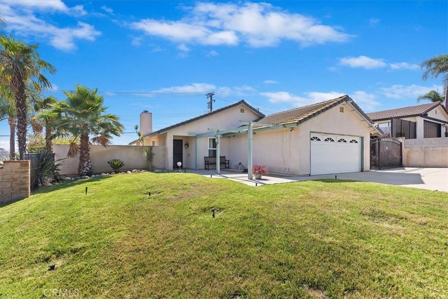 Stop Dreading Your Electric Bill —This solar-equipped single-story home is designed to keep energy costs low, thanks to approximately 16 seller-owned solar panels. Step inside to high ceilings and travertine tile that flows throughout the main living areas. The family room features a fireplace, while the kitchen offers granite countertops, a pantry, stainless steel appliances, and a separate dining area. This 4-bedroom, 2-bathroom home spans approximately 1,540 square feet and includes an indoor laundry area for added convenience. Energy-efficient upgrades include a 200-amp electrical panel, tankless water heater, and a newer Lennox HVAC system with updated ductwork for enhanced performance. You'll also find ceiling fans and recessed lighting throughout the home. The backyard offers plenty of space and potential — whether you're dreaming of custom landscaping, or a garden. A newer block wall at the rear of the property is topped with a plexiglass sound barrier for added privacy. The wide driveway allows for ample parking and potential RV access, and a freestanding patio on the side adds shaded outdoor living space. Located outside of a high fire-risk area, this home also benefits from low property taxes and no HOA. You're just a short drive to Riley Gymnasium, SilverLakes Sports Park, Eastvale Community Park, and major freeways for easy commuting.
