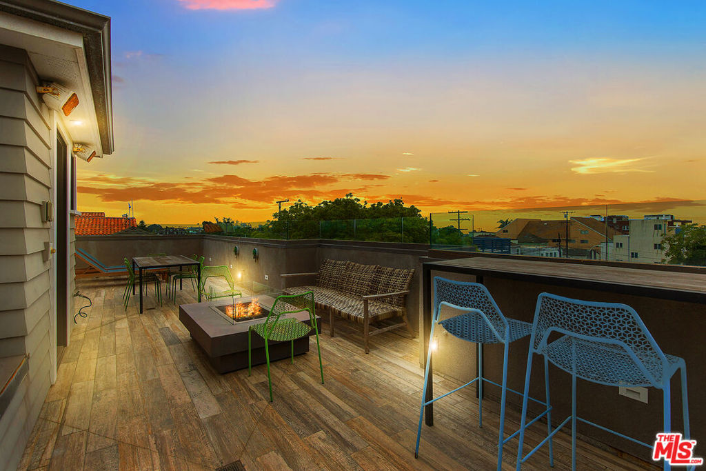 Start and end your days on the stunning rooftop deck of 106 Dudley, your front-row seat to sweeping ocean views, golden sunsets, and laid-back coastal living just one block from the beach. Built in 2018 and set on one of Venice's coveted walk streets, this contemporary Craftsman home is thoughtfully designed for the ultimate indoor/outdoor lifestyle. From the rooftop down to the private backyard, every space has been custom crafted with luxury finishes and effortless functionality. On the main level, the heart of the home is a gourmet chef's kitchen outfitted with high-end appliances, custom cabinetry, a walk-in pantry, and an expansive island perfect for hosting or daily life. The kitchen flows into the great room, which opens to the backyard through floor-to-ceiling doors that blur the line between inside and out. A dedicated dining area and a cozy den with stone fireplace add warmth and versatility. A smartly designed guest suite with a Murphy bed ideal as a home office completes the first floor. Upstairs, the spacious primary suite offers a serene retreat with a walk-in closet and spa-style bath featuring a deep soaking tub, walk-in shower, and dual vanities. Two additional bedroom search with walk-in closets share a beautifully appointed bathroom with double sinks. A central landing space makes the perfect home office, media lounge, or play area. The upstairs laundry room adds convenience right where you need it. However, it is the rooftop that truly sets this home apart--- and large deck offering the ideal backdrop for entertaining, relaxing, or simply grilling a homecooked meal in the ocean air enjoying a sunset over Venice Beach. Rounding out the property are gated front and rear outdoor spaces and a secure carport with parking for three cars. Just one block from the sand and moments to Abbot Kinney, Rose Avenue, Main Street, and one of the Westside's favorite farmers markets, 106 Dudley is a rare blend of luxury, location, and lifestyle.