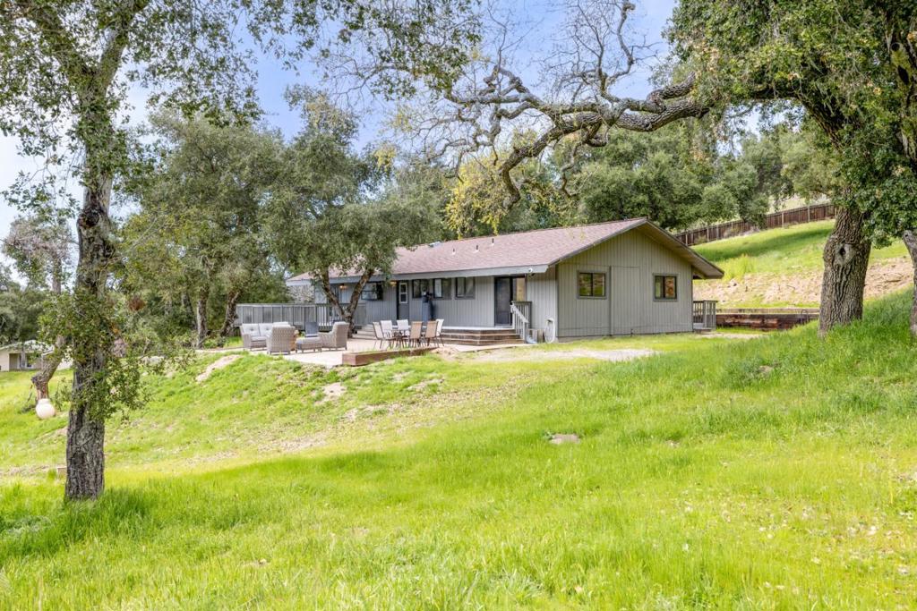 Those who seek unfiltered beauty off the beaten path will adore this breathtaking Carmel Valley compound with three separate finished residential units and panoramic mountain views. Bring your horses and ride across 11 acres of pristine land. Or, find a quiet spot to sit in deep contemplation of the grandeur of nature, understanding the meaning of true privacy like never before. We forget just how much noise modern life emits on a continual basis. And when that stops, the stillness is palpable - and oh, so beautiful. The absence of artificial sound is music to the ears, and the senses delight at the opportunity to get back to the pure essential. And yet, the property offers all the amenities you need to be comfortable. In the main house, stainless steel kitchen appliances, a Wolf double-oven and four-burner gas range, a wine refrigerator, ample cabinetry, and gorgeous countertops round out the kitchen. Admire the high vaulted wood ceilings overhead in every room: three bedrooms, two bathrooms, an open living room, and a dining area. The detached ADU offers a kitchen, and the third dwelling functions beautifully as an office with a full bathroom. Your horses can live in the pole barn. Step into the fresh air each evening to watch the sunset give way to a dark sky full of stars.