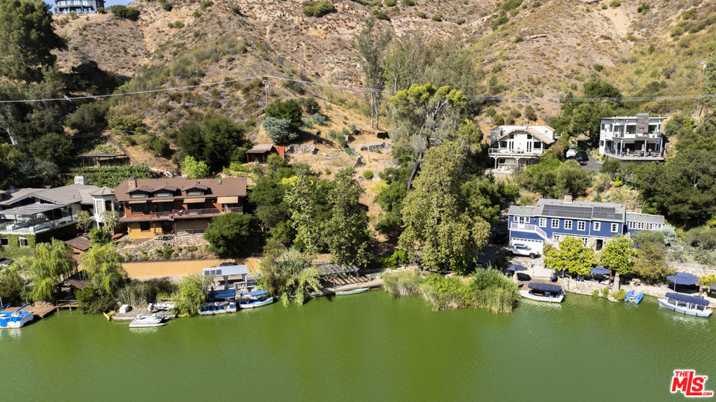 Beautiful scenic lot on approximately 3/4 of an acre, overlooking Malibu Lake. Quiet and Serene. A peaceful getaway from hectic city life. Private and tucked in nature. A private large dock accompanies the property.