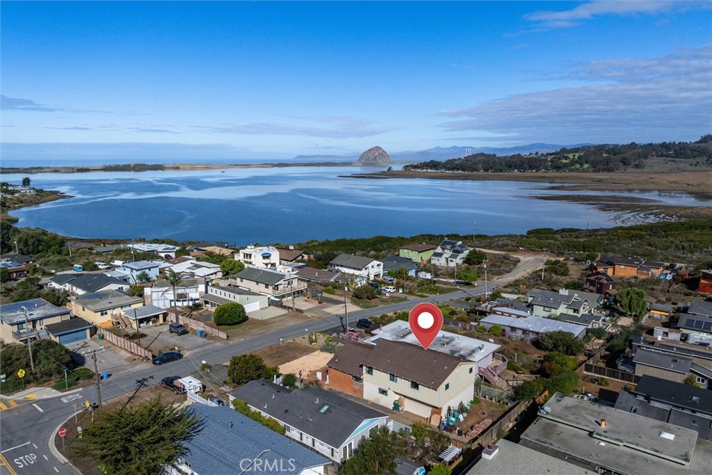 Rare opportunity to invest in a beautiful Los Osos home with stunning views of Morro Rock! This spacious 3-bedroom, 2.5-bathroom, 2,220± sq. ft. property sits on a quiet cul-de-sac just steps from the serene El Moro Elfin Forest. Step inside to discover an open-concept living area filled with natural light from floor-to-ceiling windows, flowing seamlessly into an impressive chef’s kitchen, perfect for entertaining or family gatherings. Upstairs you will find a peaceful loft-style office offers inspiring views of Morro Rock, while two sizable guest bedrooms provide comfort and privacy for family or visitors. The primary suite showcases the panoramic views of Morro Bay and the foot hills of San Luis Obispo, as well as, a walk-through closet leading to an ensuite bath, along with private access to the second-story patio where you can relax and take in the breathtaking scenery. The home is approximately 90% remodeled, with most of the materials to complete the project already on site and included in the sale. Bring your vision and finishing touches to make this stunning coastal property your own. Opportunities like this in Los Osos don’t come around often—don’t miss your chance to call this view-filled home yours!