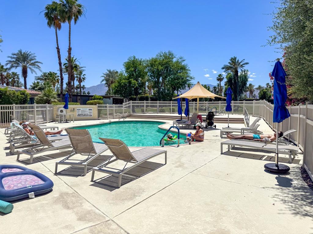 This oversized 3,920 sq. ft. luxury RV lot at Outdoor Resort Indio offers nearly twice the space of a standard lot and an unbeatable location just steps from the satellite pool, hot tub, sauna, and laundry. Designed for Class A motorcoach owners who enjoy the RV lifestyle, this unique property is full of delightful surprises--including an arched golf cart parking area and a secluded, hedge-enclosed 'room' perfect for outdoor dining or private entertaining. A small hidden grass lawn offers a space for pets or future personalization, while two sun shelters shade the expansive stainless kitchen area. Additional seating at the rear of the lot provides a peaceful retreat with a glimpse of the golf course--ideal for relaxing after a swim or soaking in the sun. With generous parking and resort-style amenities all around, this lot is both a spacious retreat and full of potential.‍Outdoor Resort Indio is a Class A only RV resort in Indio, CA.