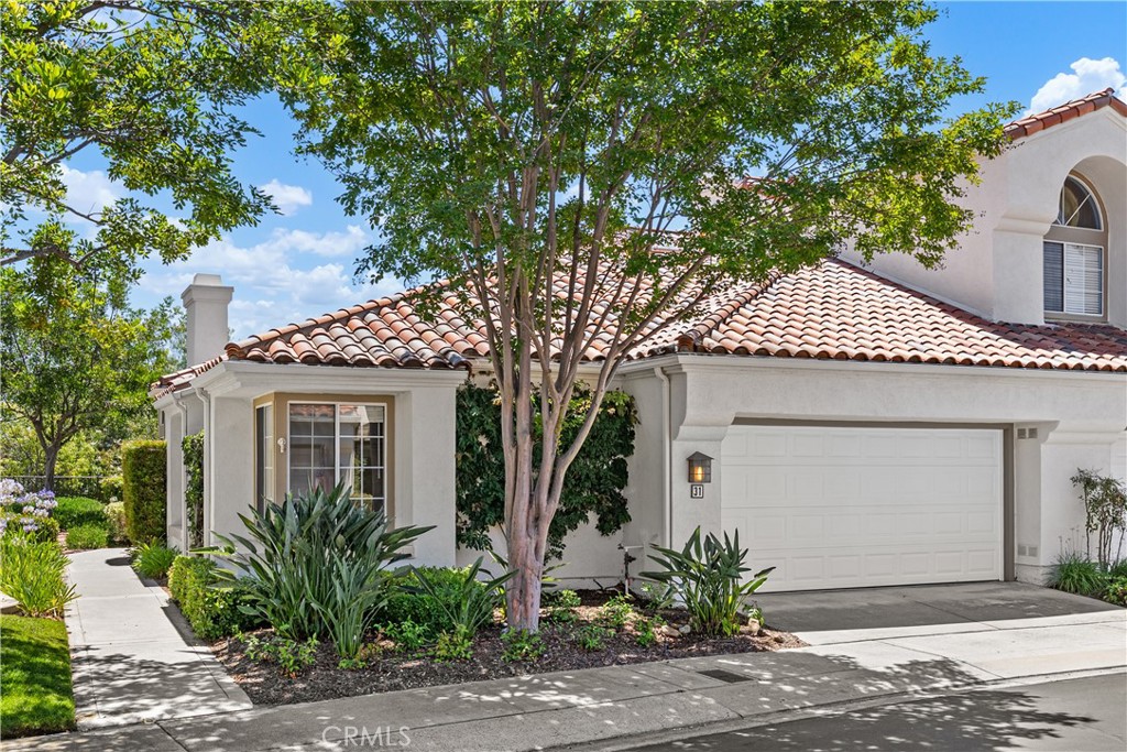 31 Calle Maria sits at the end of a cul de sac on a quiet street within walking distance to Santa Margarita Lake, shopping, and restaurants. With only 105 homes, this popular Marbella community is known for its well-kept landscapes and graceful streets. This is the only single story floorplan in the community, with soaring ceilings, tons of natural light, and a private elevated backyard. The primary en suite bedroom opens to the yard, has dual walk-in closets, and double vanities. The secondary bedroom is at the opposite end of the home and an oversize garage can accomodate "toys galore". The property has been freshly painted, new Luxury Vinyl Plank flooring and tall baseboards throughout. New stainless steel kitchen appliances have just been added. The Association pool overlooks the Lake and Rancho Santa Margarita offers numerous amenities, including pools, sports fields, lake fishing, a sand bottom swimming lagoon, tennis and pickleball, and much more. Ready for immediate move-in.