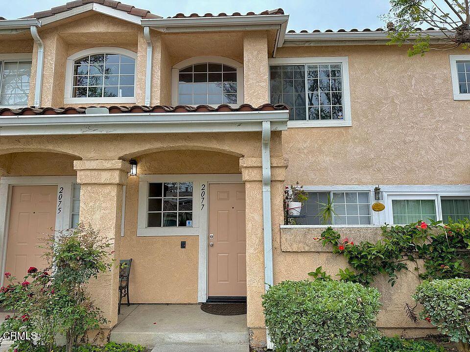 Welcome to 2077 Blackberry Circle, a charming townhome tucked inside the secure and beautifully landscaped Las Brisas community in North Oxnard. With 1,362 square feet of living space, this home feels bright and airy thanks to its open layout, vaulted ceilings, and abundant natural light. The living room is perfect for relaxing by the fireplace, while the kitchen offers plenty of counter space and storage for all your culinary adventures.Upstairs, you'll find comfortable bedrooms, including a spacious primary suite with a private bath. Step outside to your own patio--ideal for morning coffee or unwinding after a long day. Residents here enjoy access to a sparkling pool, and lush green spaces, making it feel like a resort year-round.Families will love the proximity to highly rated schools: Rio Del Norte Elementary (8/10, less than a mile away), Rio Vista Middle School (7/10), and Pacifica High School (6/10).You're also just minutes from The Collection at RiverPark, where you'll find Whole Foods, Target, Yard House, and plenty of restaurants and shops. Grab a coffee at Starbucks or catch a movie at Century RiverPark 16--all within easy reach.With quick freeway access and everything you need close by, this home truly offers the best of Oxnard living. Don't miss your chance to make it yours!
