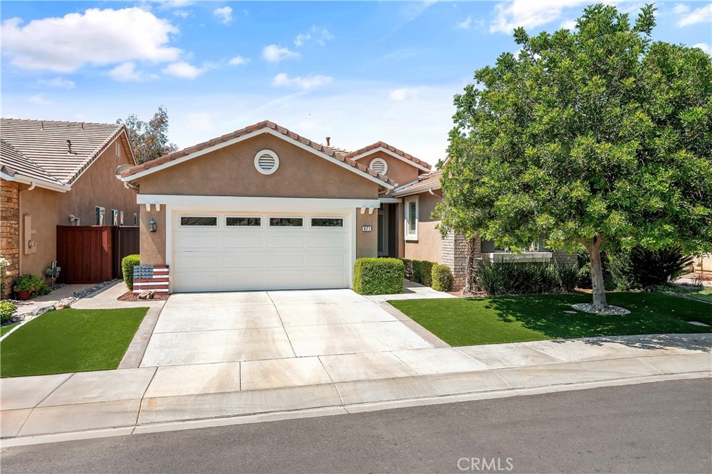 Beautiful 55+ single-story home in the gated community of Four Seasons, featuring breathtaking views of the golf course and surrounding hills in Hemet. The property offers artificial grass in the front yard and a low maintenance back yard, located on a private cul-de-sac. Thie home offers 2 bedrooms, a versatile office/den, and 2 bathrooms across 2071 sqft of thoughtfully designed living space. Enjoy the benefit of being in a low tax area. Inside you will be greeted by a spacious and open floor plan that seamlessly connects every room. The combination of tile and carpet flooring adds a touch of elegance, while the paint scheme throughout enhances the overall ambiance. At the entry of the home, there is a versatile den/office with carpet flooring, a ceiling fan, and ample natural light through the window with stylish shutters. The hallway bathroom includes a shower/tub combo, single sink vanity, and tile flooring. The spacious living room is highlighted by windows with stylish shutters that fill the space with natural light. It features a fireplace, vaulted ceilings, and a ceiling fan for comfort. A sliding glass door provides seamless indoor-outdoor living, offering easy access to the backyard and showcasing stunning golf course views. From here, you will find the kitchen, featuring tile flooring, plenty of storage in the cabinets, and a kitchen island. Stainless steel appliances, including a stove and oven, microwave, dishwasher, and recessed lighting, make cooking a delight. This kitchen seamlessly opens to the dining area. The master bedroom is a true retreat, with carpeting, shutters on the windows, and a ceiling fan. The master bathroom boasts a walk-in closet, dual sinks with a vanity sitting area, a soaking tub, a spacious walk-in shower, and an additional closet with sliding doors for extra storage. The guest bedroom is equally inviting, with carpet flooring, a closet, ceiling fan and shuttered windows. This home also offers the convenience of a laundry room with garage access, a wash sink and built-in cabinets. Outside to the backyard, with low-maintenance landscaping and a breathtaking golf course view, creating a perfect setting for relaxation. The covered patio and low maintenance landscape contribute to an inviting outdoor oasis. Embrace an active and carefree lifestyle with an array of amenities tailored to the 55+ senior community. Four Seasons offers 24/7 gated security provides safety and peace of mind for all residents and their guests.
