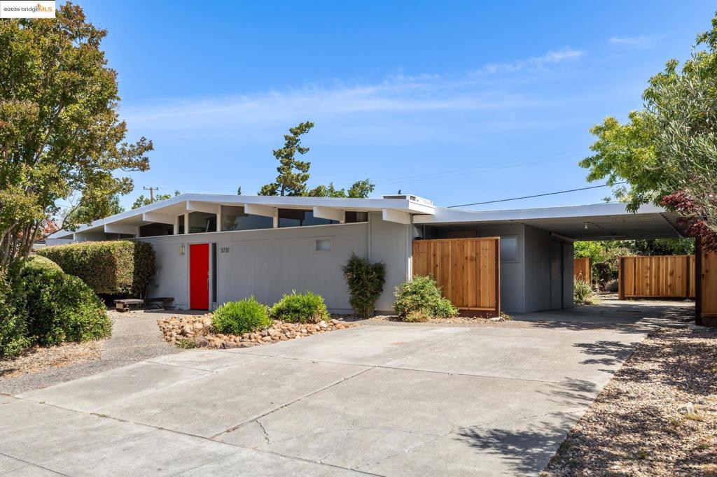 Step into one of the largest and most distinctive Eichler homes in Concord’s coveted Parkwood Estates neighborhood. This rare 4BD, 2.5BA mid-century modern residence spans an expansive 2,435 SF (per tax records). At the heart of the home lies the signature interior atrium—a serene space that brings light and nature into the core of the home. Floor-to-ceiling glass walls frame lush outdoor views and flood the interior with natural light, seamlessly blending indoor and outdoor living. Classic tongue-and-groove ceilings, globe lighting, and the open-concept layout embody the timeless appeal of Eichler architecture. Unique to this property is the addition of a generous family room, offering flexible space for entertaining, relaxing, or working from home. Step outside to a sprawling backyard oasis complete with a sparkling pool—perfect for cooling off on warm Concord summer days. The property also boasts a brand-new foam roof, forced air heating and air conditioning for year-round comfort, and a carport that presents potential for future enclosure.
