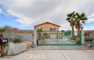 MOTIVATED SELLER!!! ALL REASONABLE OFFERS CONSIDERED!!! Welcome to this Desert Oasis with Natural Mineral Hot Spring & Indoor Pool/Spa! Imagine endless possibilities: like a private family estate, a wellness retreat center, or a resort-style vacation rental. EVERYTHING is PERMITTED. This 0.92 Acre Lot is Zoned W2, is in the UNINCORPORATED area of Riverside County. The Main home has an expensive 3,672 SQFT. of Living Space with 5 bedrooms, 3 bathrooms. The upstairs and downstairs are not internally connected. Downstairs has a kitchen area, 4 bedrooms and 2 bathrooms. Upstairs has a foyer, dining area, living room, large kitchen, family room and main bedroom with bathroom. The separate indoor pool building features a full catering kitchen, large meeting room, two separate bathrooms with open showers, large pool and spa feed by a natural mineral hot spring well. There is a separate building formally used as a Chapel that can be used as a Arts/Culture Venue, Community Hub, Residential Space, or Social Services Venue. The Outdoor Area FEATURES: a 30’ x 100’ Concrete Slab, Pergola, with Concrete Table and Benches perfect for entertaining or outdoor meeting area. The property is Fully Fenced with 1 Remote-Controlled Gate. Embrace a lifestyle of health, relaxation, and potential income. Contact today for a private showing!
