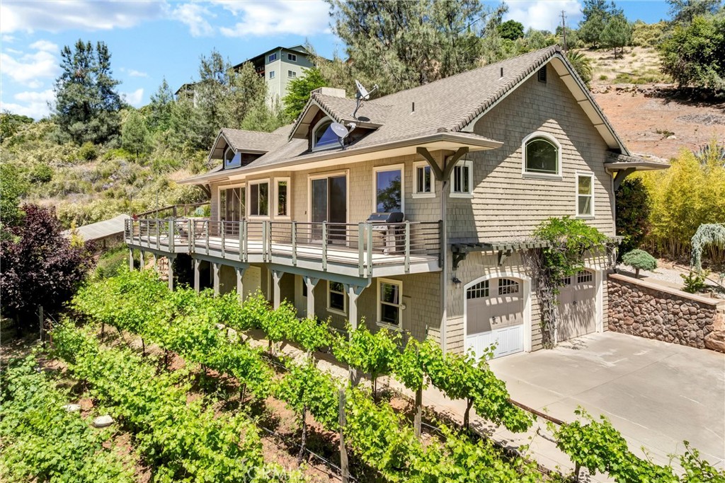 Enjoy Lakeside Living with Stunning Views!
Discover the charm and versatility of this spacious home in Kelseyville, offering panoramic views of Clear Lake and Mt. Konocti. Designed for flexible living, this multi-level home is ideal for a variety of uses and lifestyles.
Upstairs, the bright and open layout features a comfortable living area with a fireplace, formal dining space, and an open kitchen perfect for everyday use or hosting. Two generously sized bedrooms include a primary suite with sliding doors that open onto a large deck, along with a walk-in closet, and an ensuite bath featuring a walk-in shower and separate soaking tub.
Downstairs, a private-entry lower level includes a third bedroom, home theater, and wet bar, offering a great opportunity for a guest suite, creative studio, or recreation area.
The outdoor space is equally impressive, complete with a koi pond and waterfall, established grape vines, and multiple areas to relax or gather. The large driveway and additional parking offer ample space for vehicles, boats, or recreational equipment.
Located less than a mile from a public boat launch and marina, this home provides easy access to water activities such as boating, kayaking, and fishing on Clear Lake. Situated at the base of Mt. Konocti and surrounded by vineyards, local markets, and dining, this property offers a welcoming balance of natural beauty and community amenities.