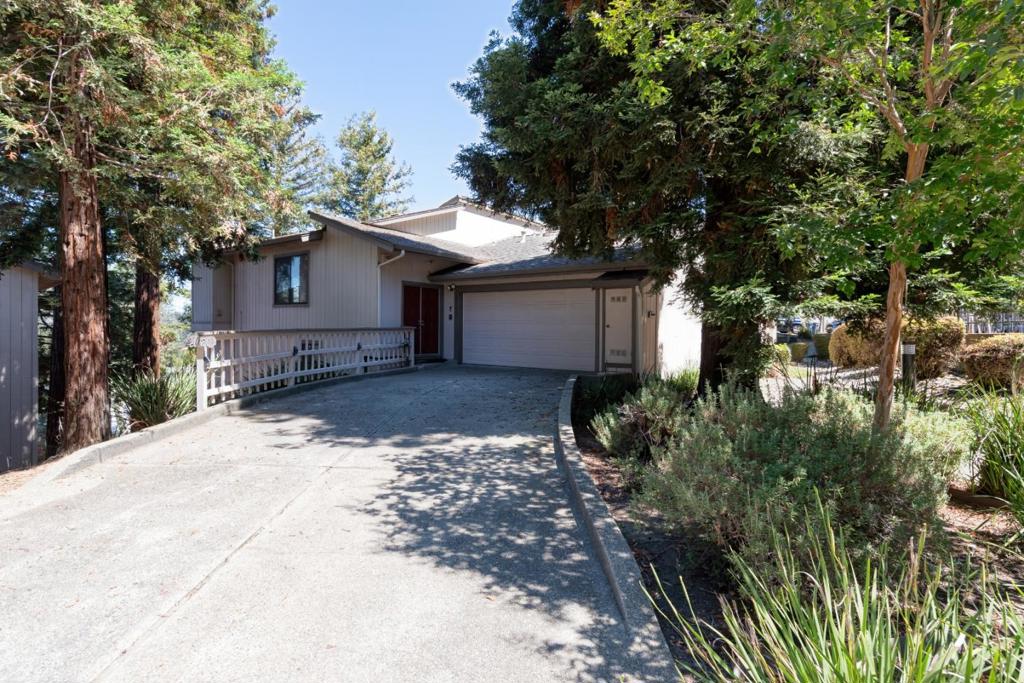 This spacious 2-bedroom, 2.5-bathroom townhome is nestled in a peaceful and serene community just minutes from Hayward Hills. The inviting living room features soaring vaulted ceilings, leading into a bright kitchen equipped with a built in oven (can use as convection or regular oven) and microwave combo, and a generous walk-in pantry. The open dining area boasts high ceilings and flows seamlessly onto a private balcony with tranquil views of majestic redwood trees. Downstairs, you'll find two well-sized bedrooms, each with full closets, plus two additional walk-in closets one of which has been converted into a office space, while the other includes a closet system. The primary suite features a double-sink vanity, private ensuite bathroom, and access to a second large balcony perfect for relaxing. A separate laundry room with built-in storage cabinets is located on the same level as the bedrooms for added convenience. Enjoy the expansive attached two-car garage, complete with extra space and an overhead storage loft. This unit features the longest driveway in the community and is just steps from the pool and jacuzzi yet remains quiet and private inside. Surrounded by nature with deer and wild turkeys roaming the grounds, this home offers easy access to 580, 238, 92 & 880