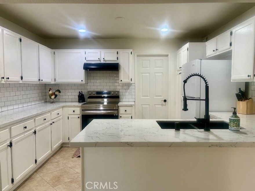 Welcome to your new beach home! Spacious single level has been tastefully updated in the kitchen and both bathrooms. Samsung appliances including oven and brand new dishwasher. Laundry room with full size Electrolux washer and dryer. Fresh paint and with newly installed carpet. The spacious primary suite has a walk-in closet, retreat area, and large private balcony. This home may be used as a 2-bedroom with an office or a 3 bedroom when an armoire is added. Enjoy golf course and city lights views from the two balconies. Homeowners association includes grounds keeping, security, pool maintenance, insurance, trash, water, and maintains 2 swimming pools/spas. This home is an end unit with a short walking distance to the beach.