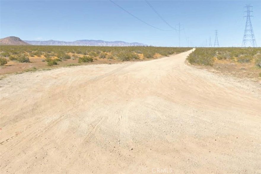 Investors and solar developers have been fighting over this one for years. 2.5 level acres just north of paved Backus Rd. with overhead power.  Great investment opportunity. Just north of the city of Rosamond with easy access to the 14 freeway north and south.